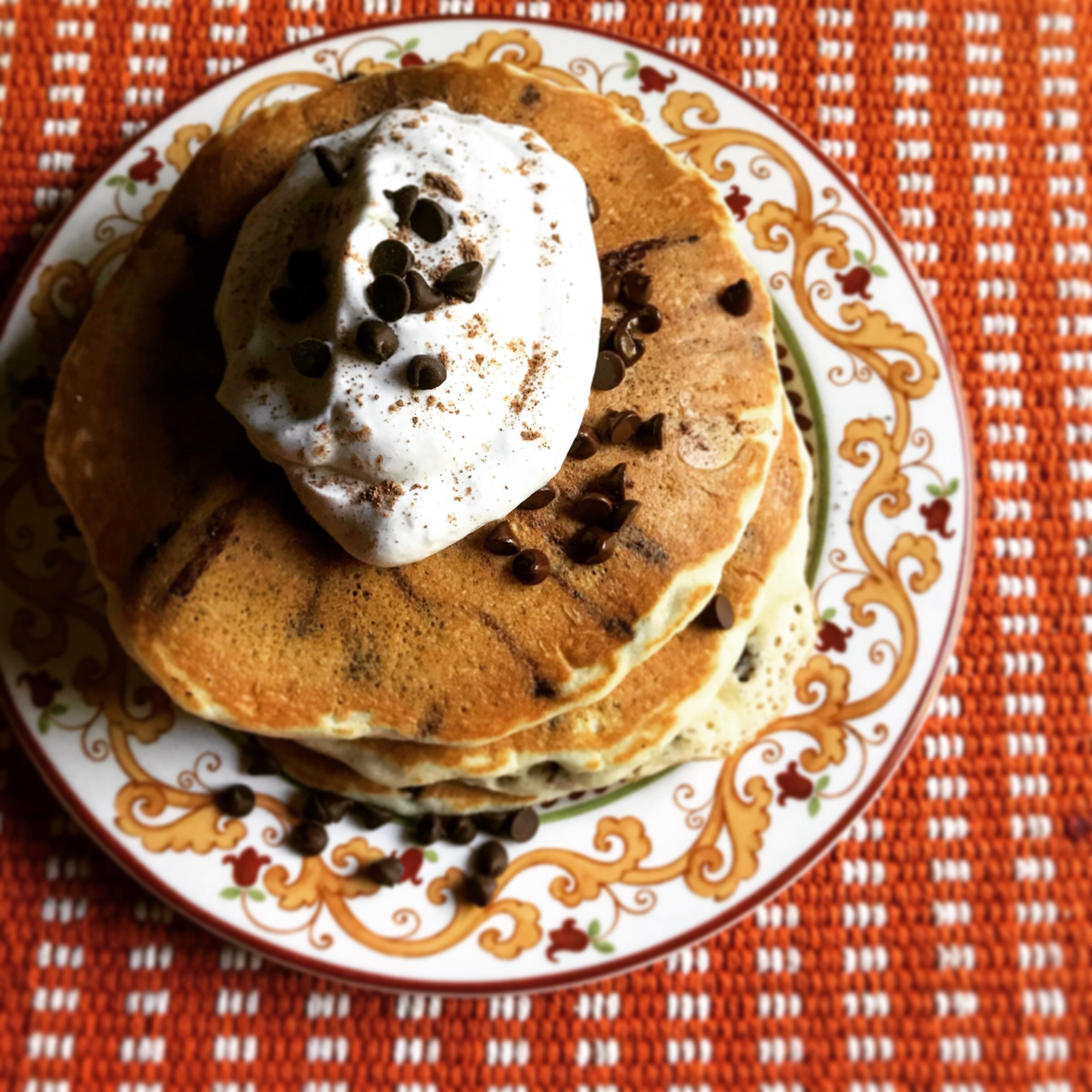 [homemade] Chocolate chip pancakes with more chocolate chips on top and fresh whipped cream. r