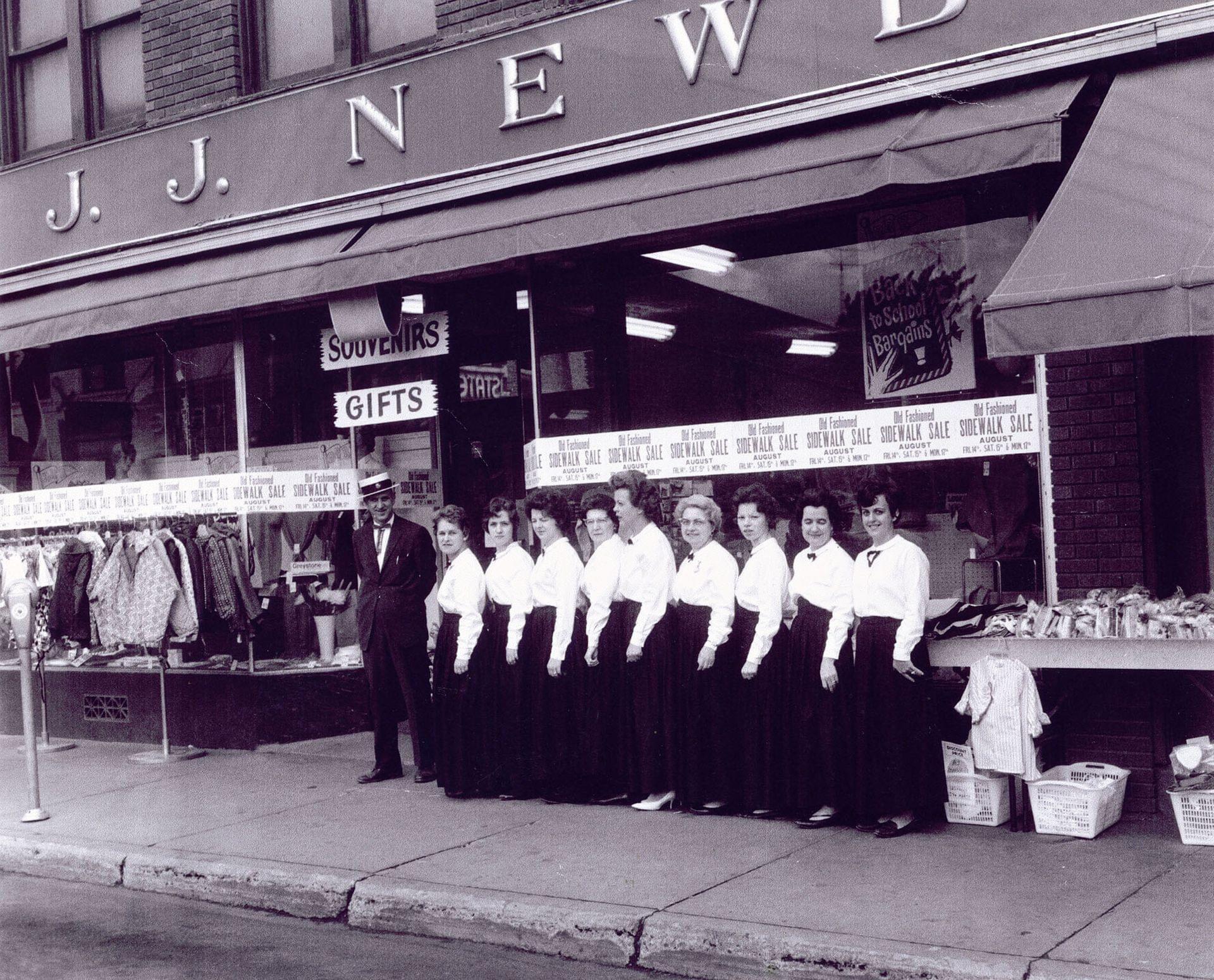Female employees and Ambrose Marquis (the owner) in front of the J.J