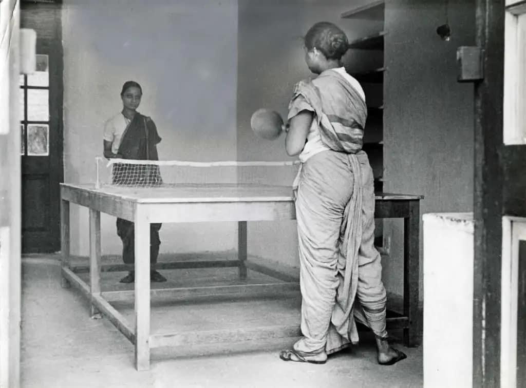 Two Marathi women playing table tennis draped in Kashta sarees in