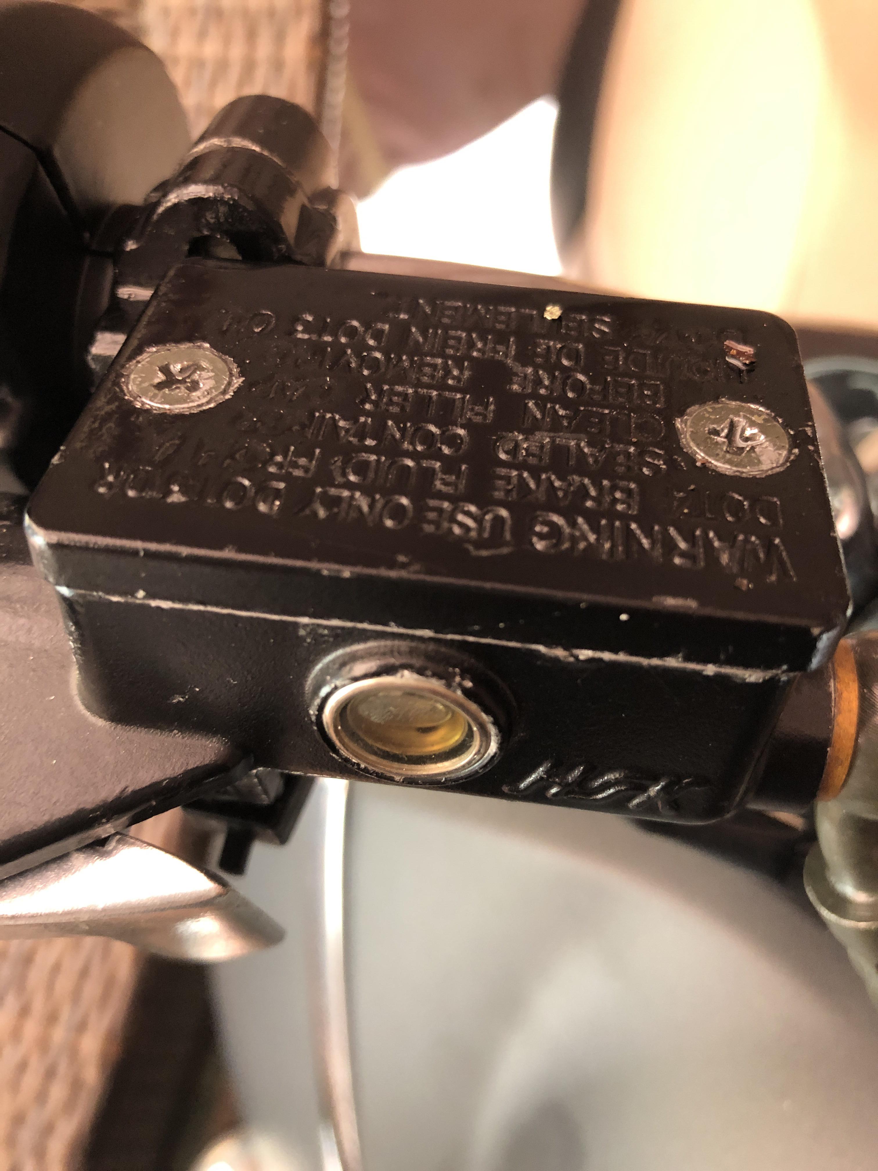 Need tips for removing the brake fluid lid screws already tried some