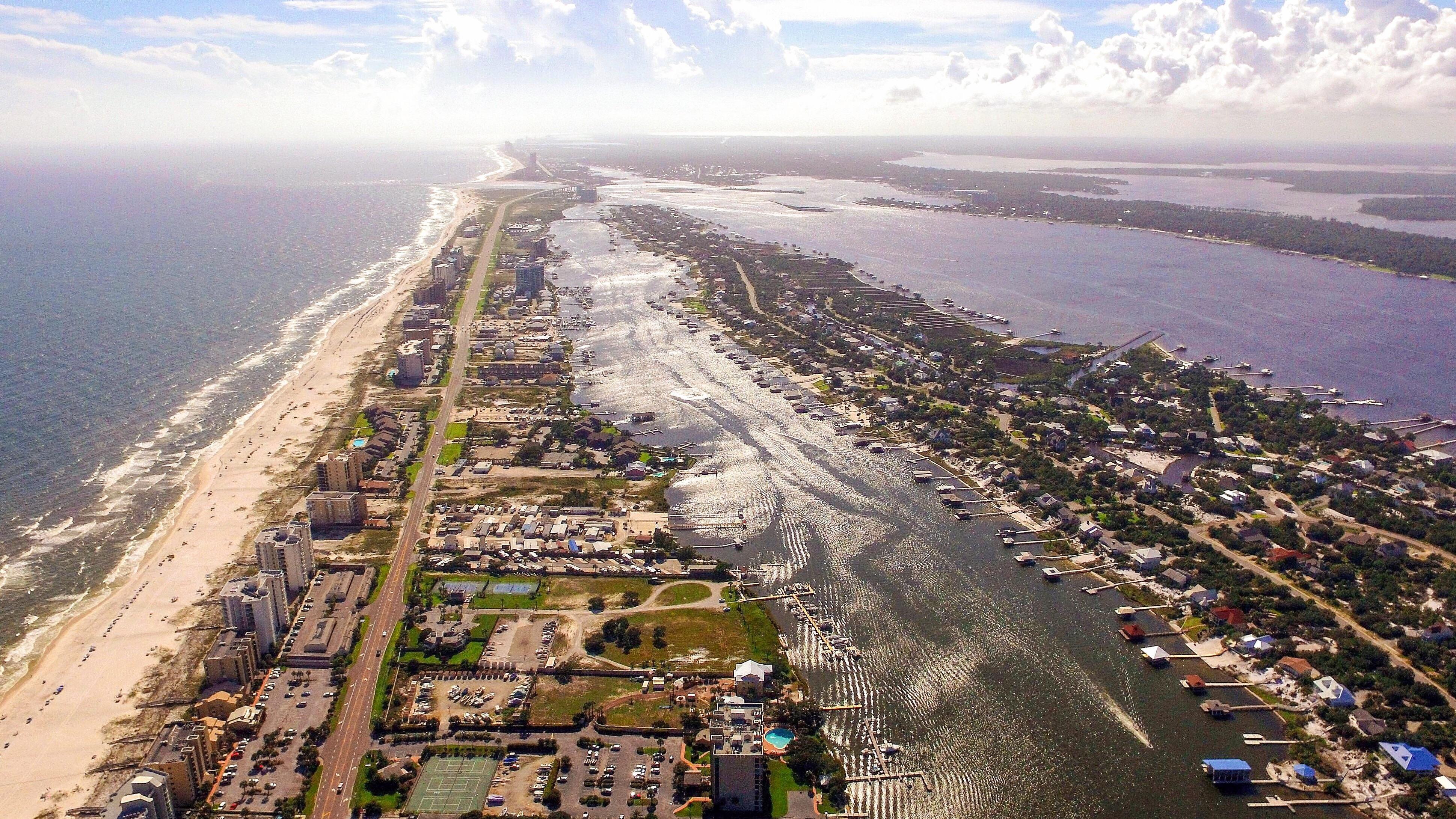 Aerial shot above the Florida/Alabama state line, looking west over