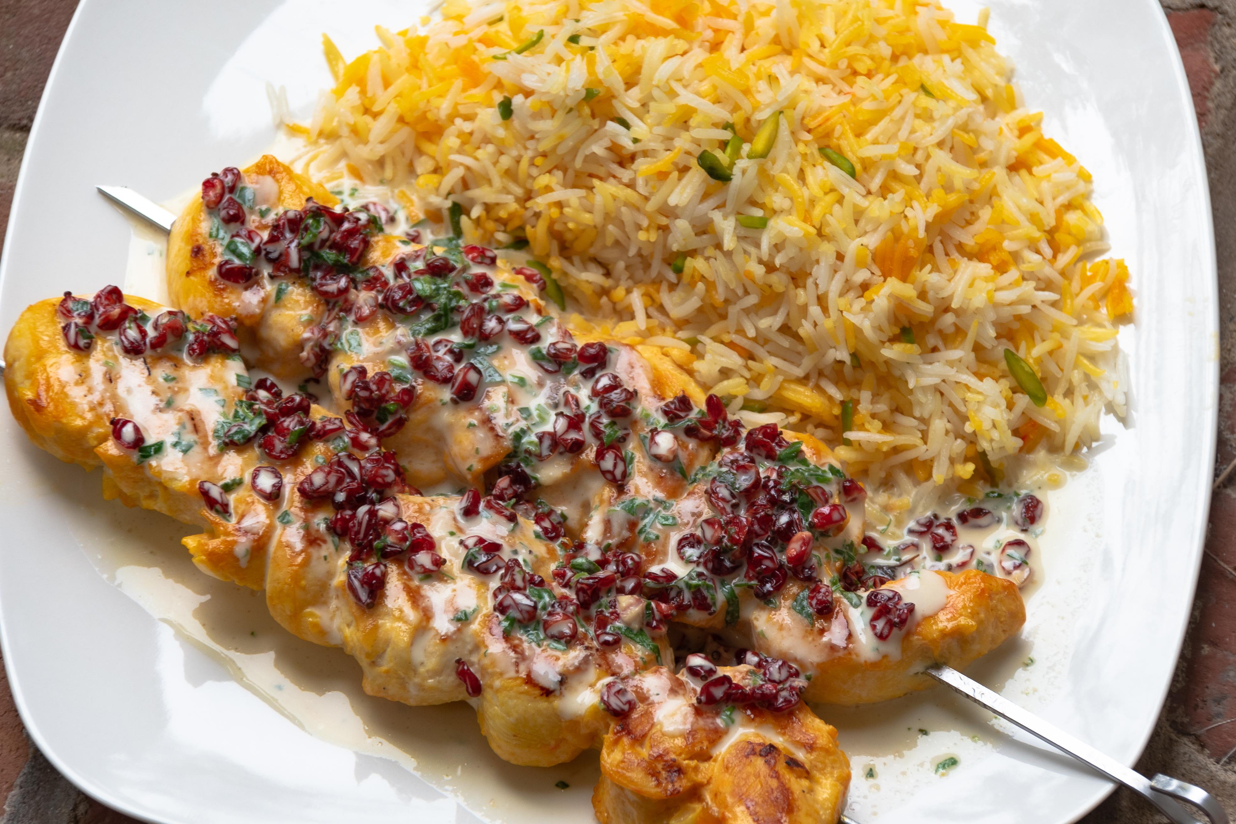 Persian saffron chicken kebab topped with a barberry tarragon creame