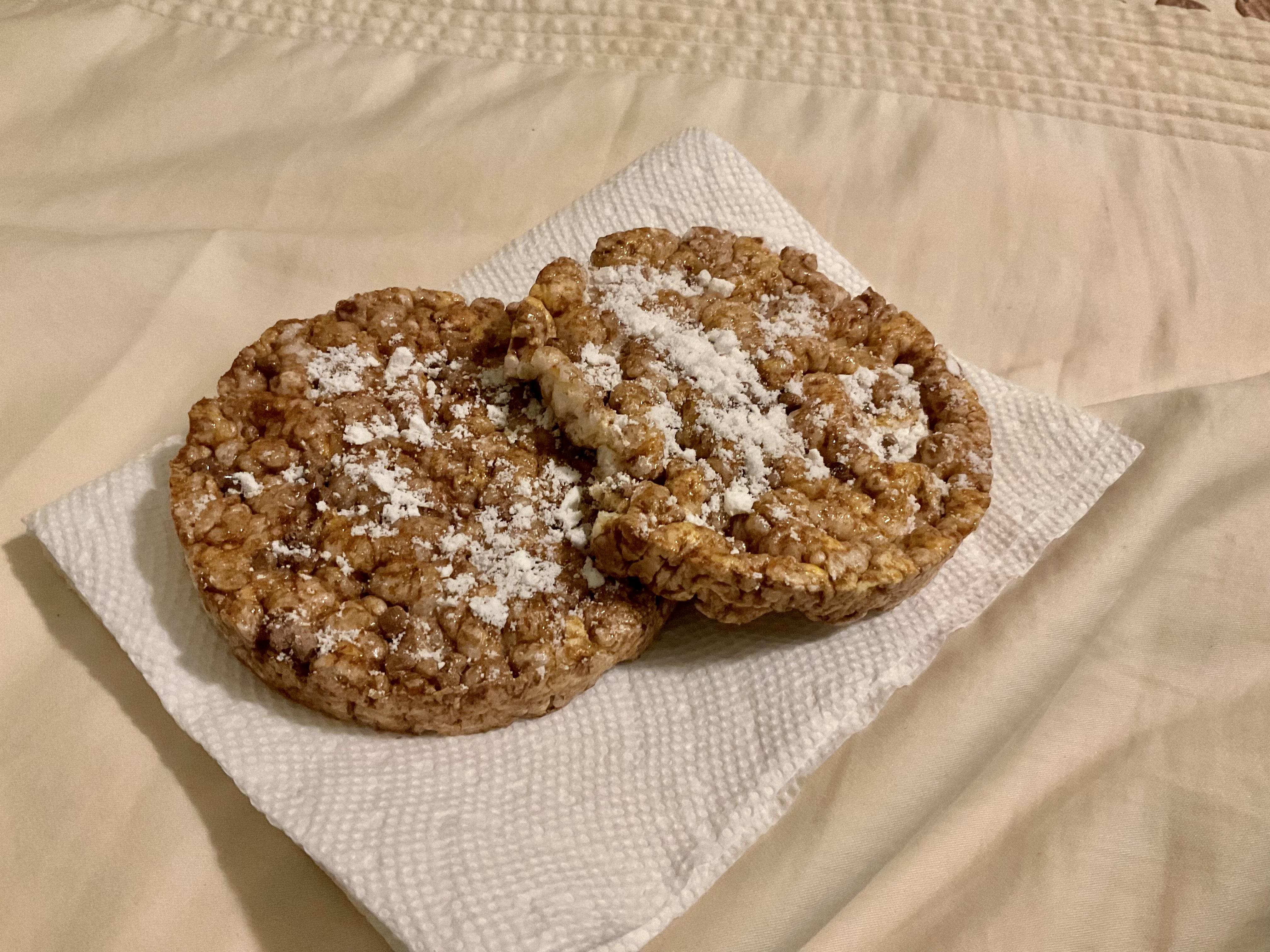 2 chocolate caramel rice cakes topped with confectioners swerve for