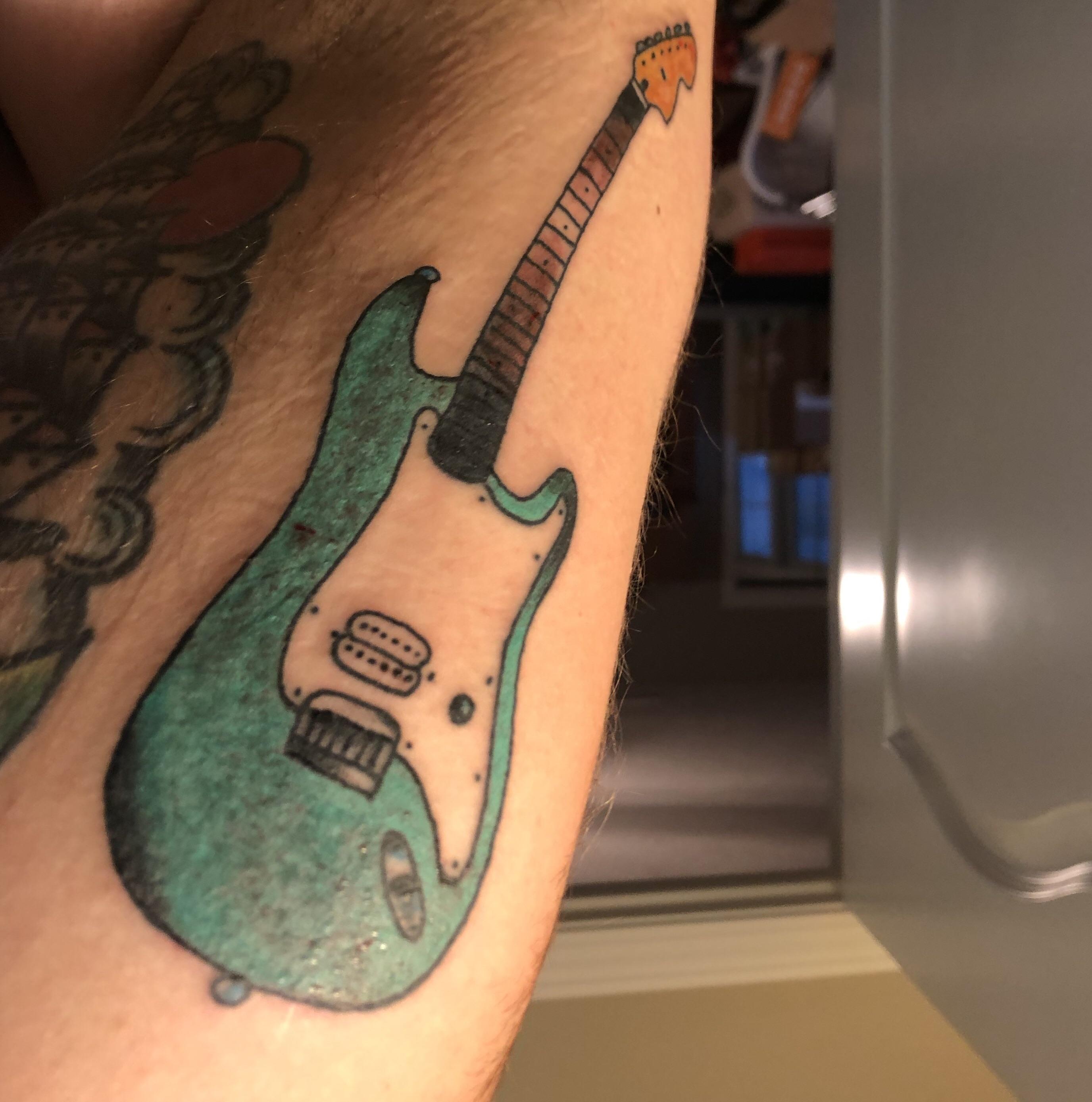 I got a tattoo based on Tom Delonge’s Strat (tattoo looks