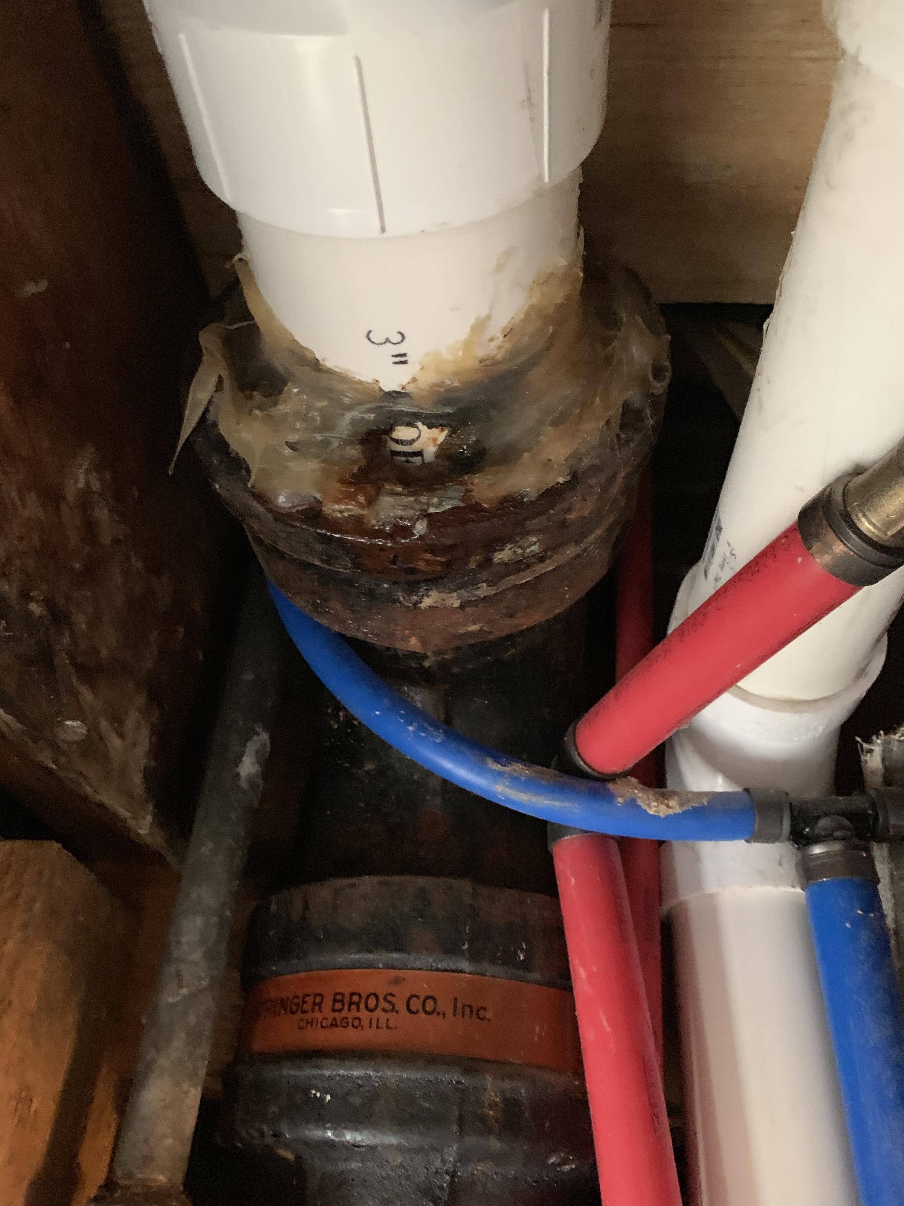 How do I reseal this and with what? The white pipe at the top feeds to