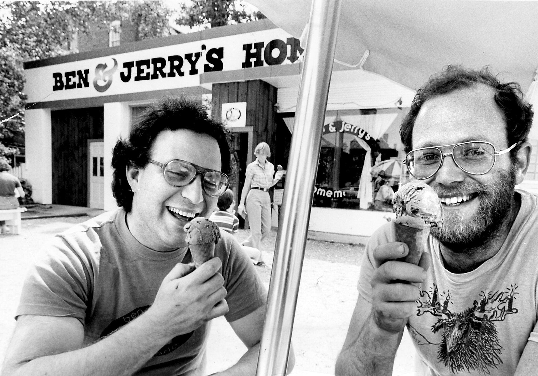 Jerry Greenfield and Ben Cohen eating Ben & Jerry's ice cream at their