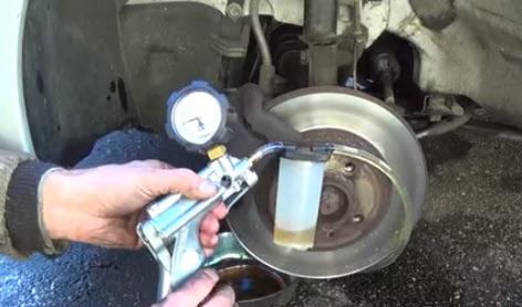 When opening bleeder screw and compressing calipers for new pads would