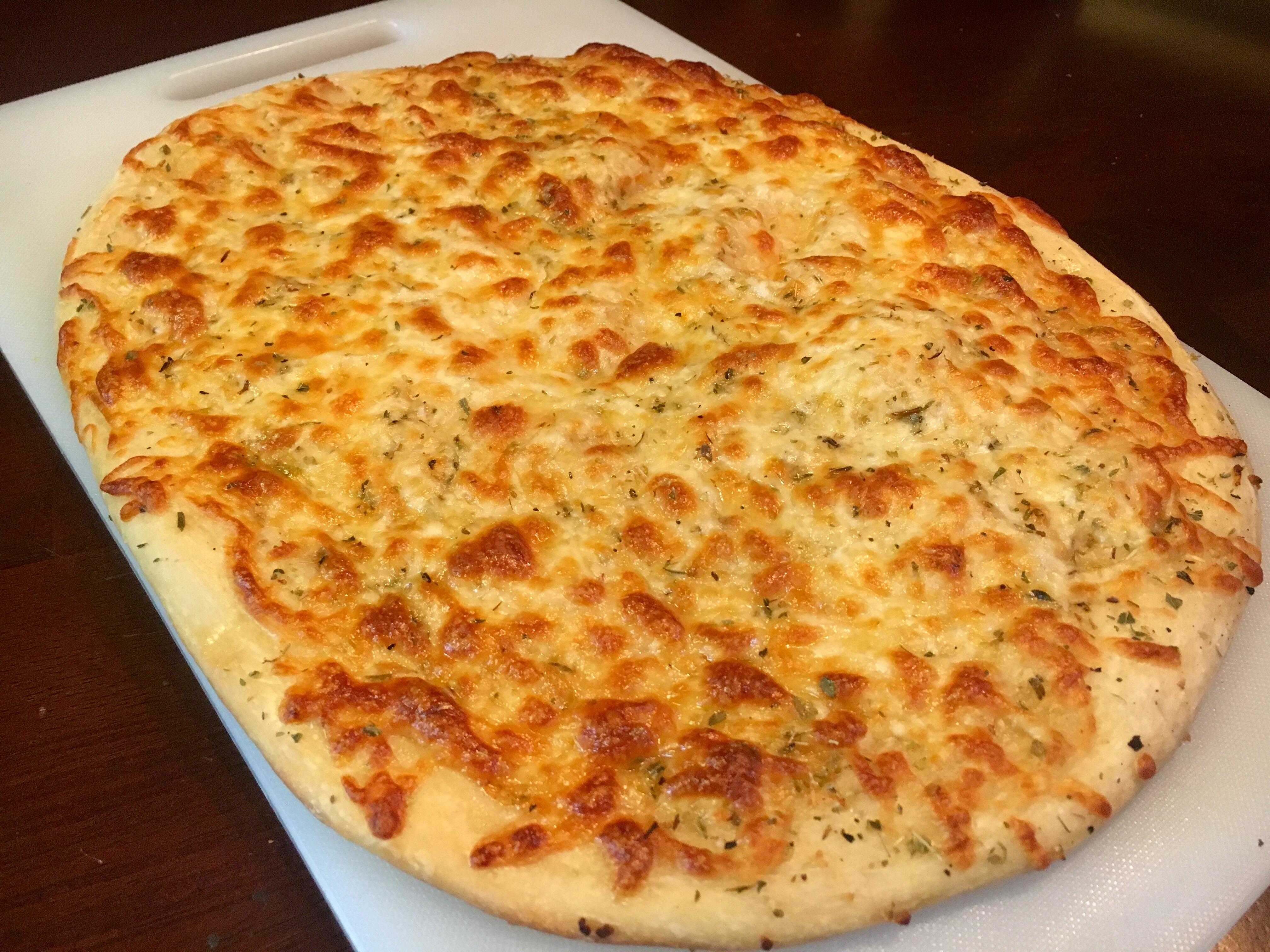 White pizza with garlic, olive oil, oregano, mozzarella and provolone