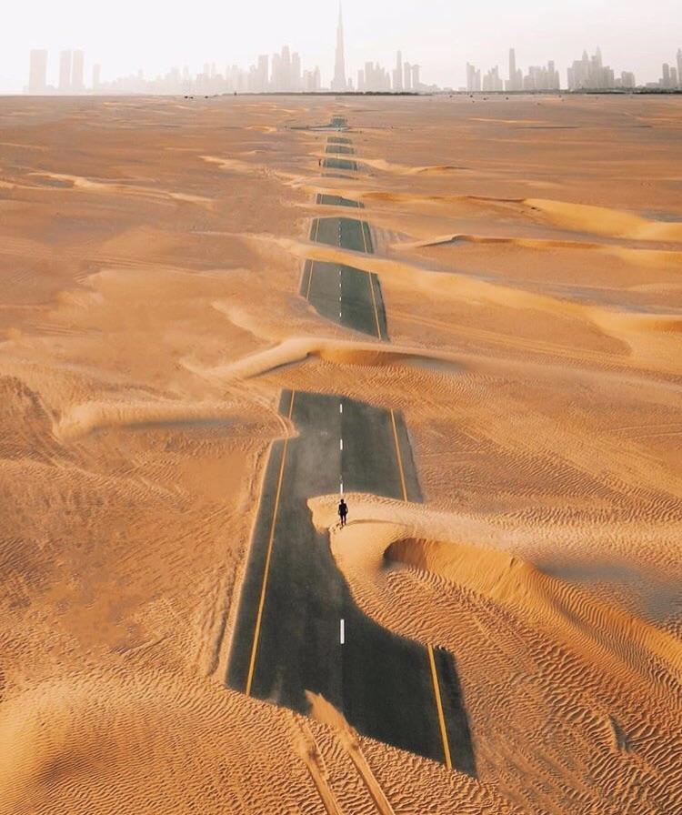 A road in Dubai covered in sand. r/pics
