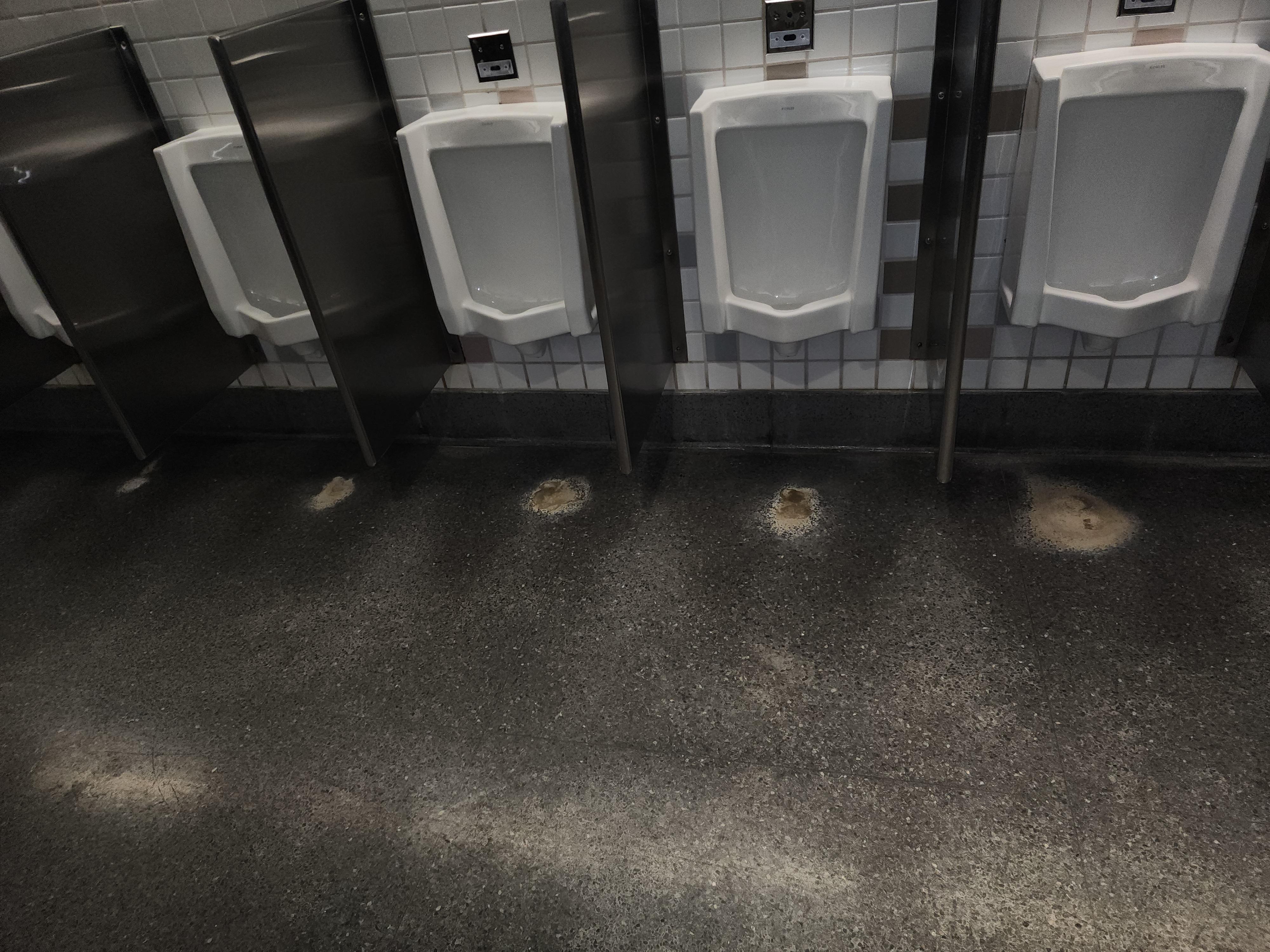 This bathroom in the Denver airport has increasing sizes of urine