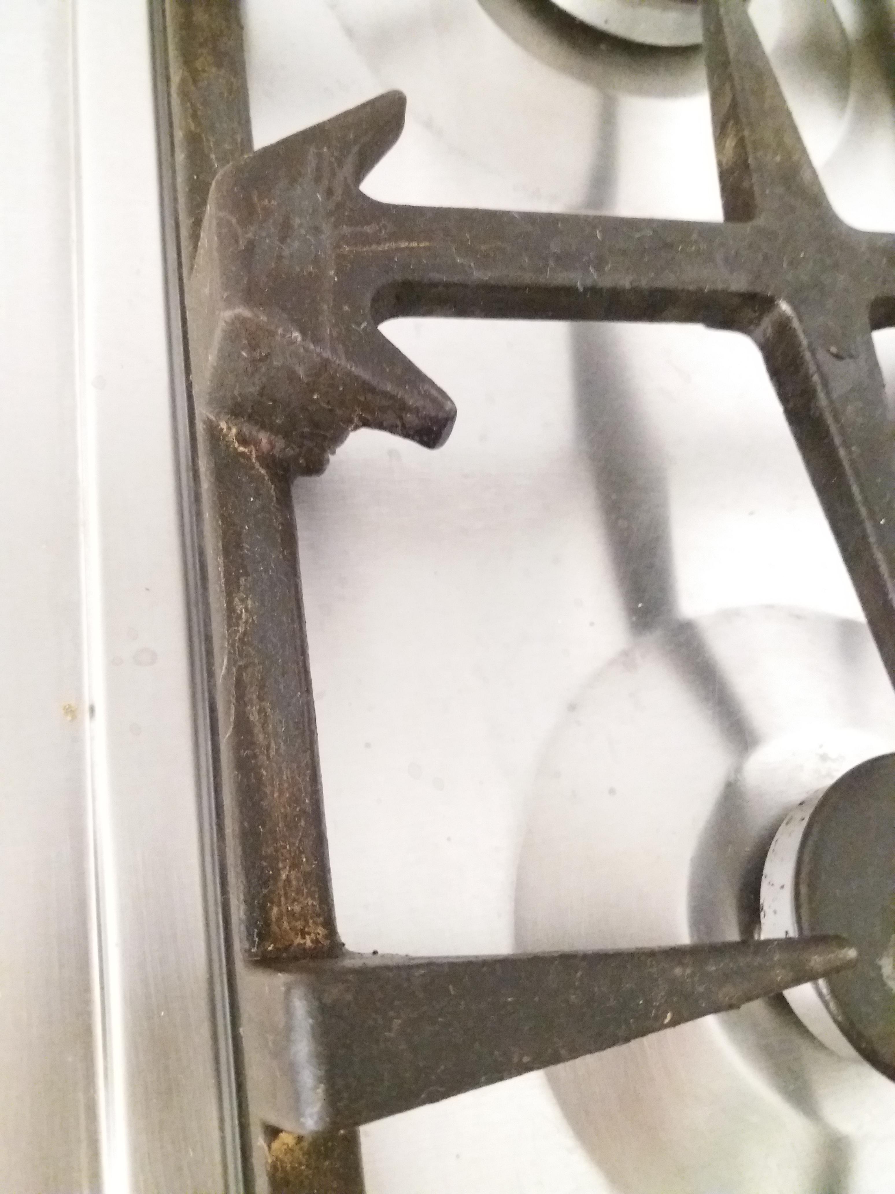 How can I get grime off my kitchen stove grate? Scrubbing is extremely