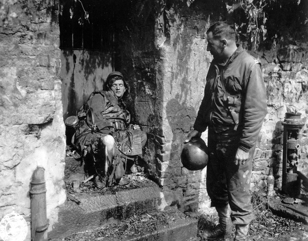 US Infantryman from 39th ID inspects a dead German Nazi soldier killed