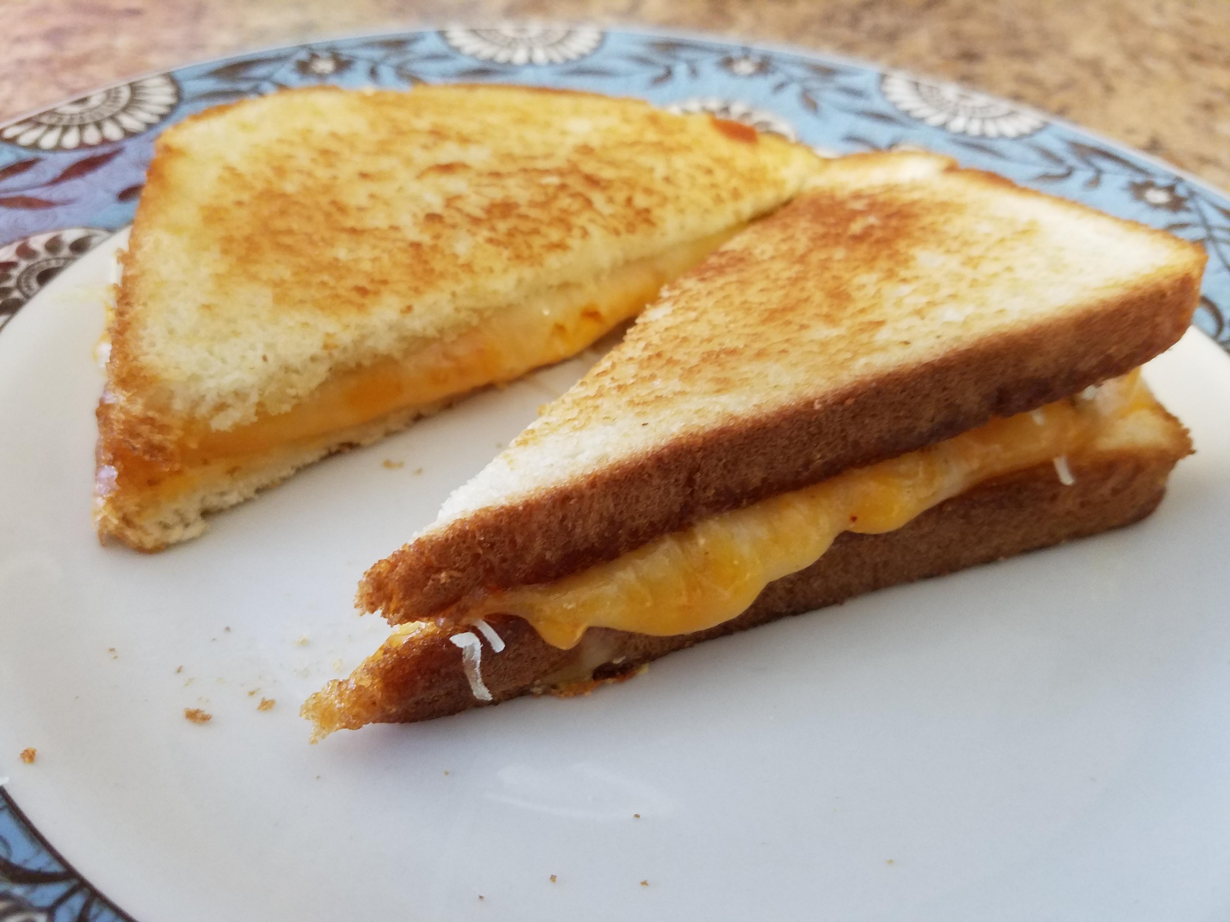 Mozzarella and spicy Colby Jack in butter and olive oil on white