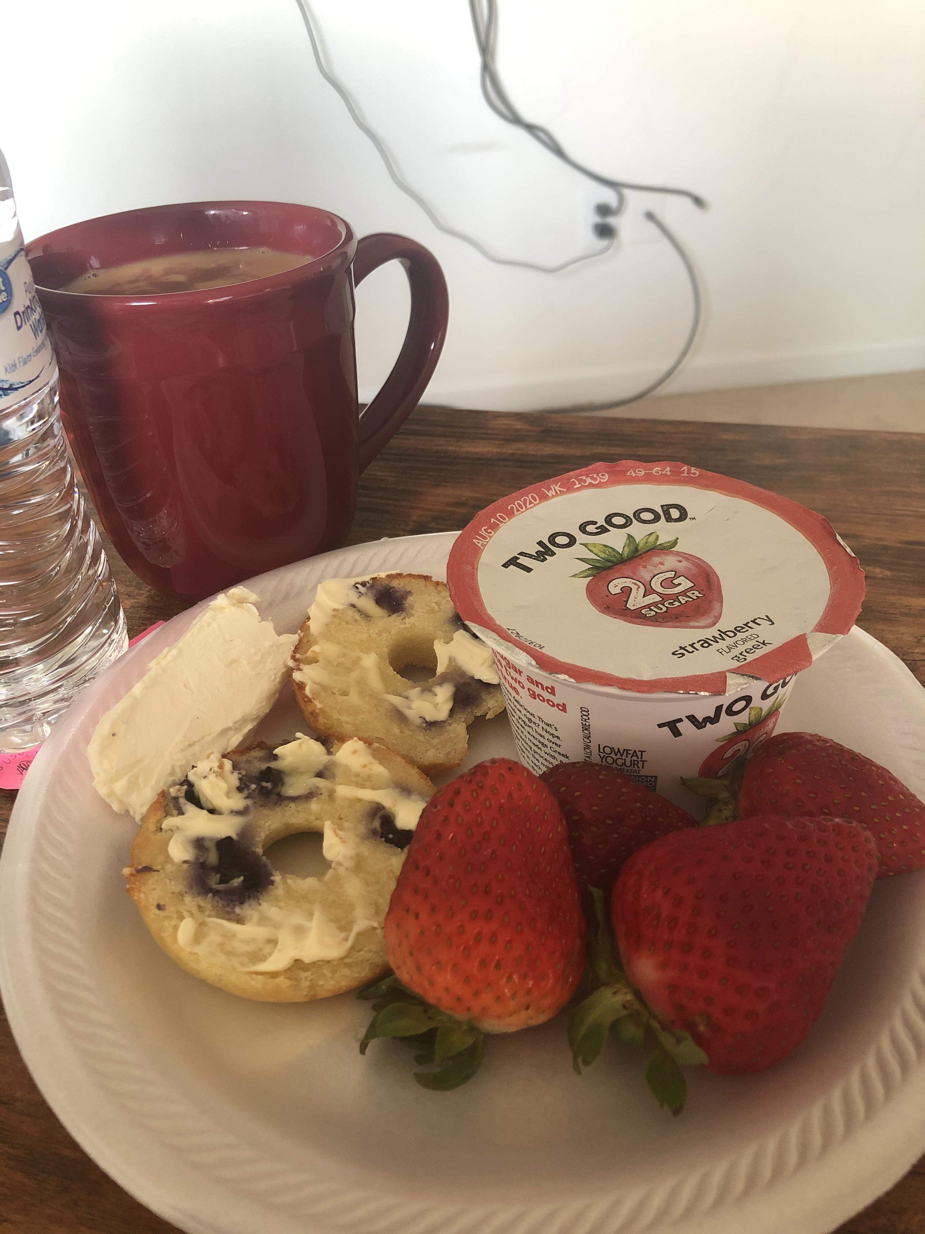 Keto blueberry bagels, toasted with butter, cream cheese, strawberries