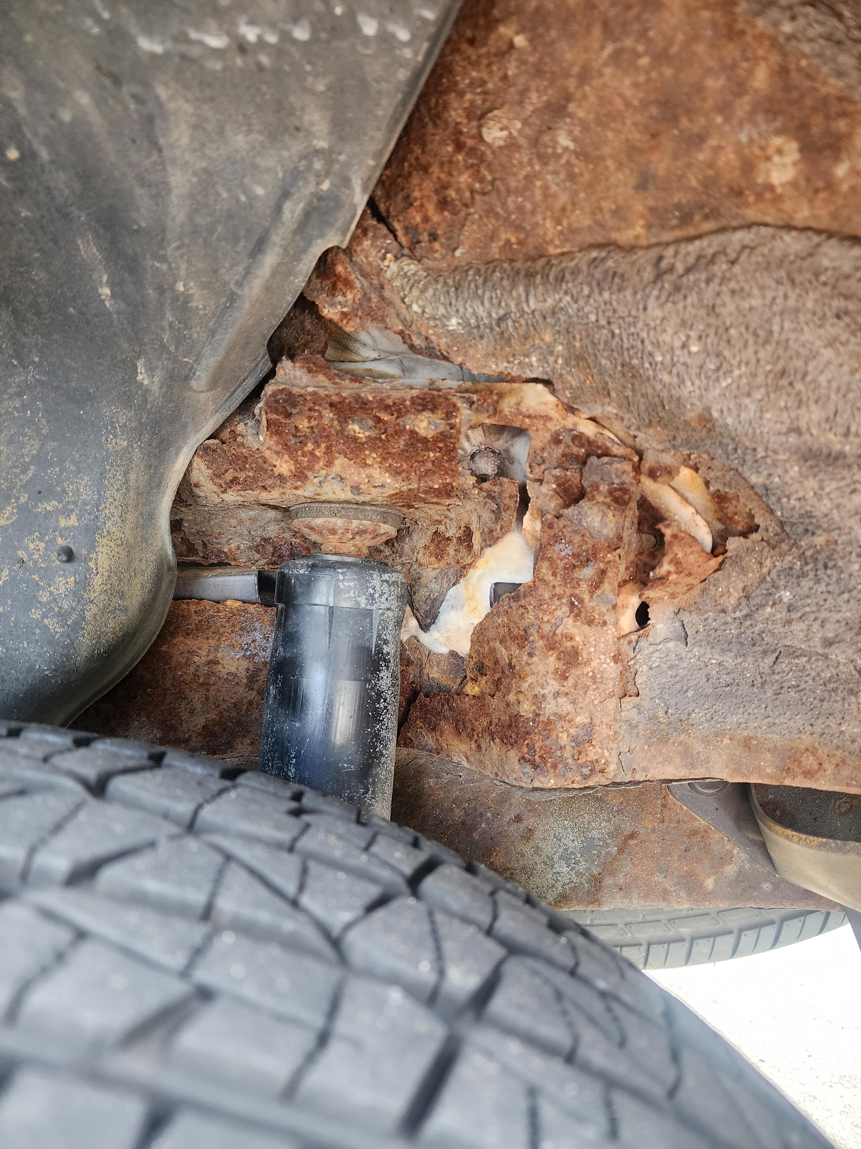 Rust ate through the frame & the shock absorber is loose bangin around