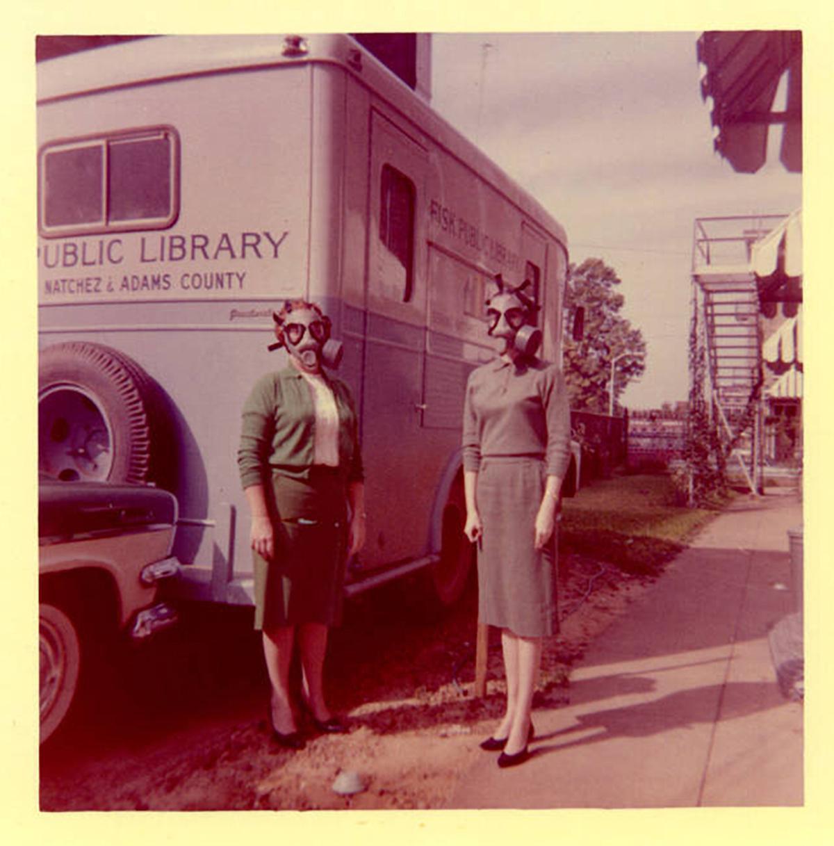 [1962 • Natchez, Mississippi] Librarians wear gas masks during