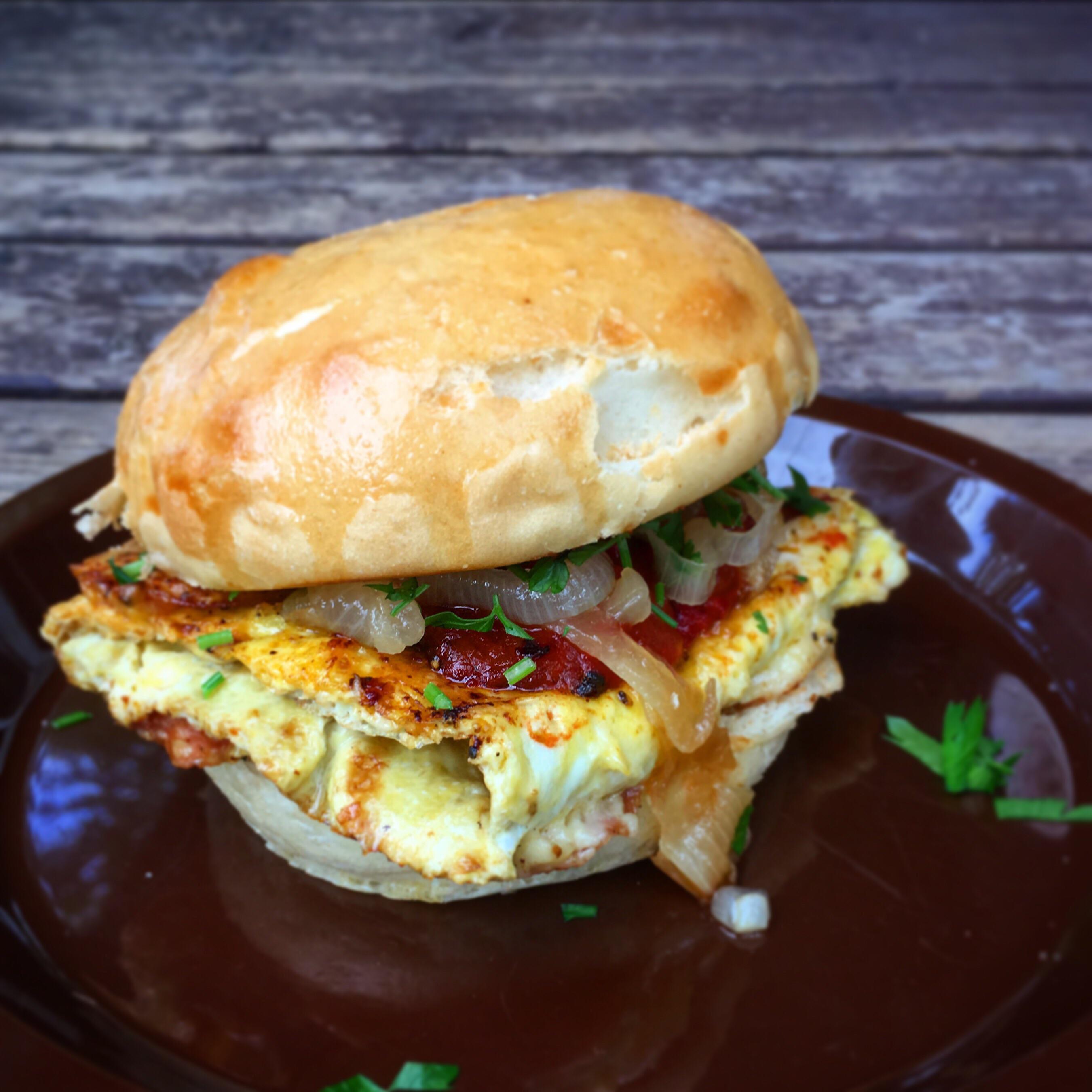 Omelette sandwich I made for breakfast pepperoni & cheddar omelette, fried tomato, onion and