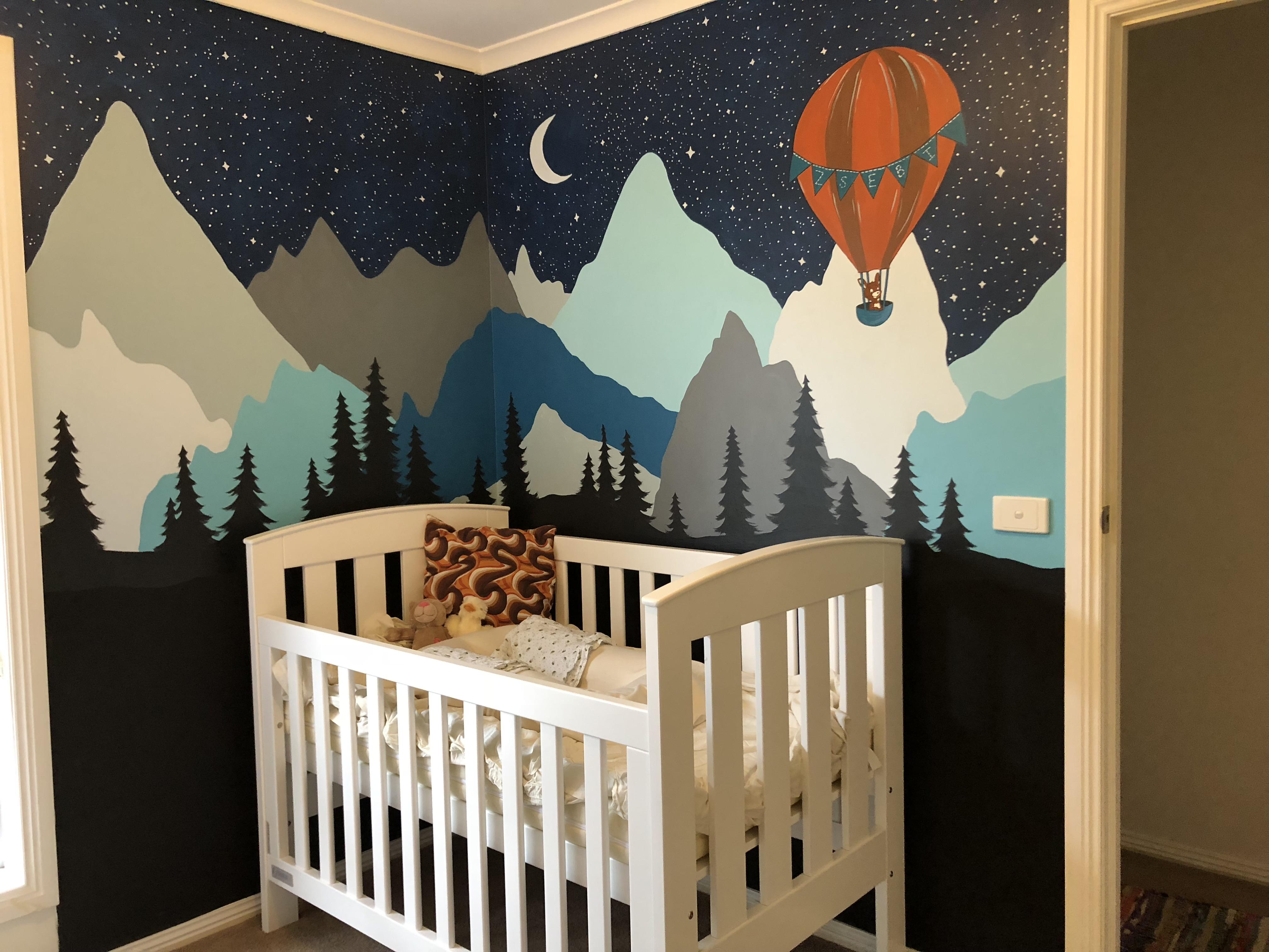 A mountainous night sky mural with chalkboard paint at the bottom for