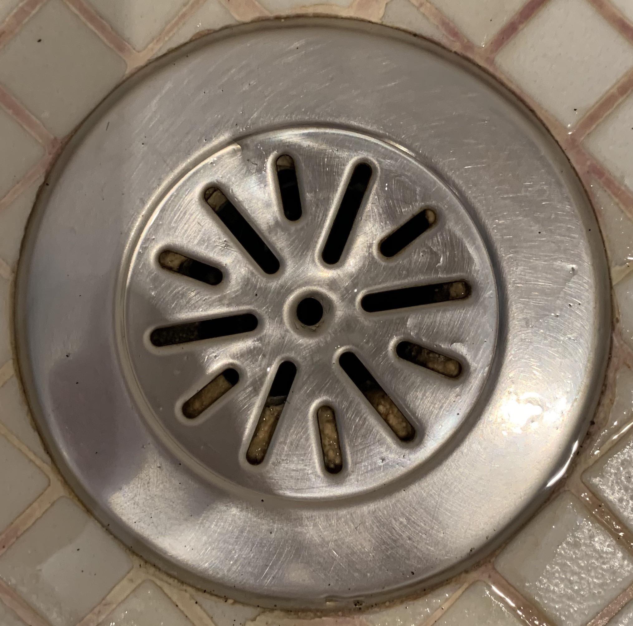 What happens when hair goes down this shower drain in concrete floor
