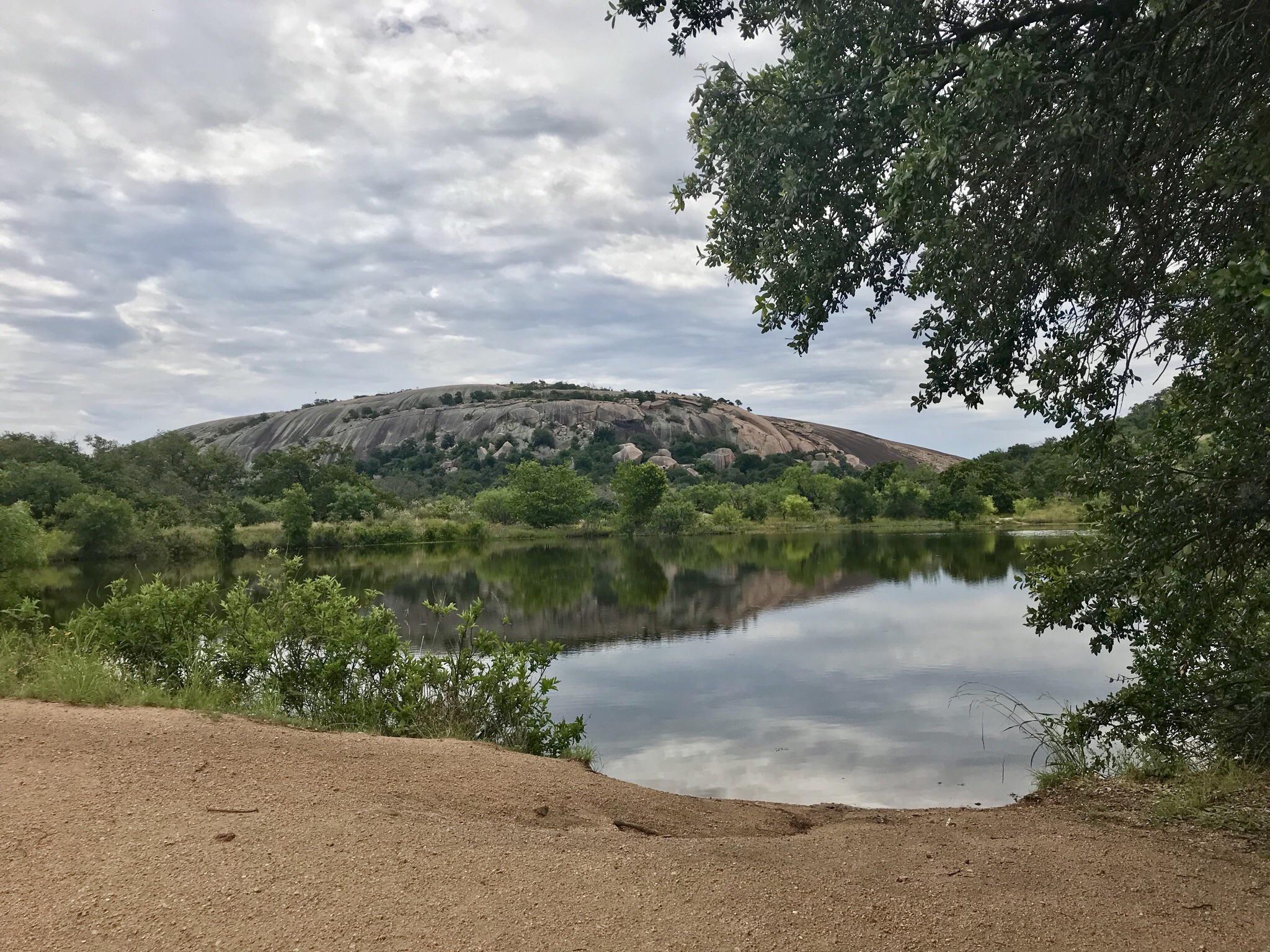 Enchanted Rock framed by Moss Lake. Texas hill country. r/camping