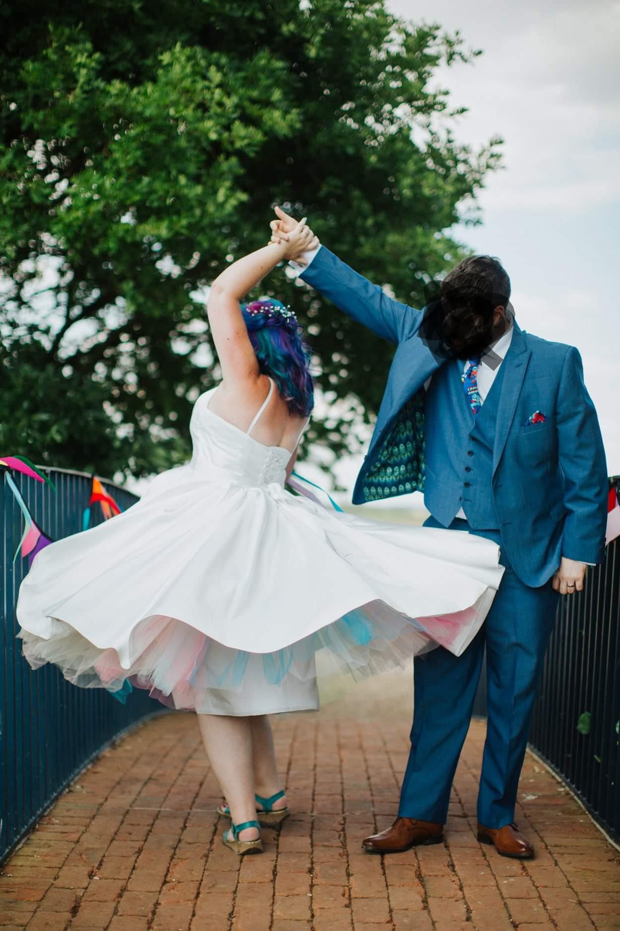 Reposted to blur husband's face, rainbow wedding dress and hair