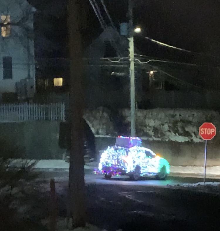 Anyone know the story of this car covered in lights absolutely blasting Feliz Navidad driving