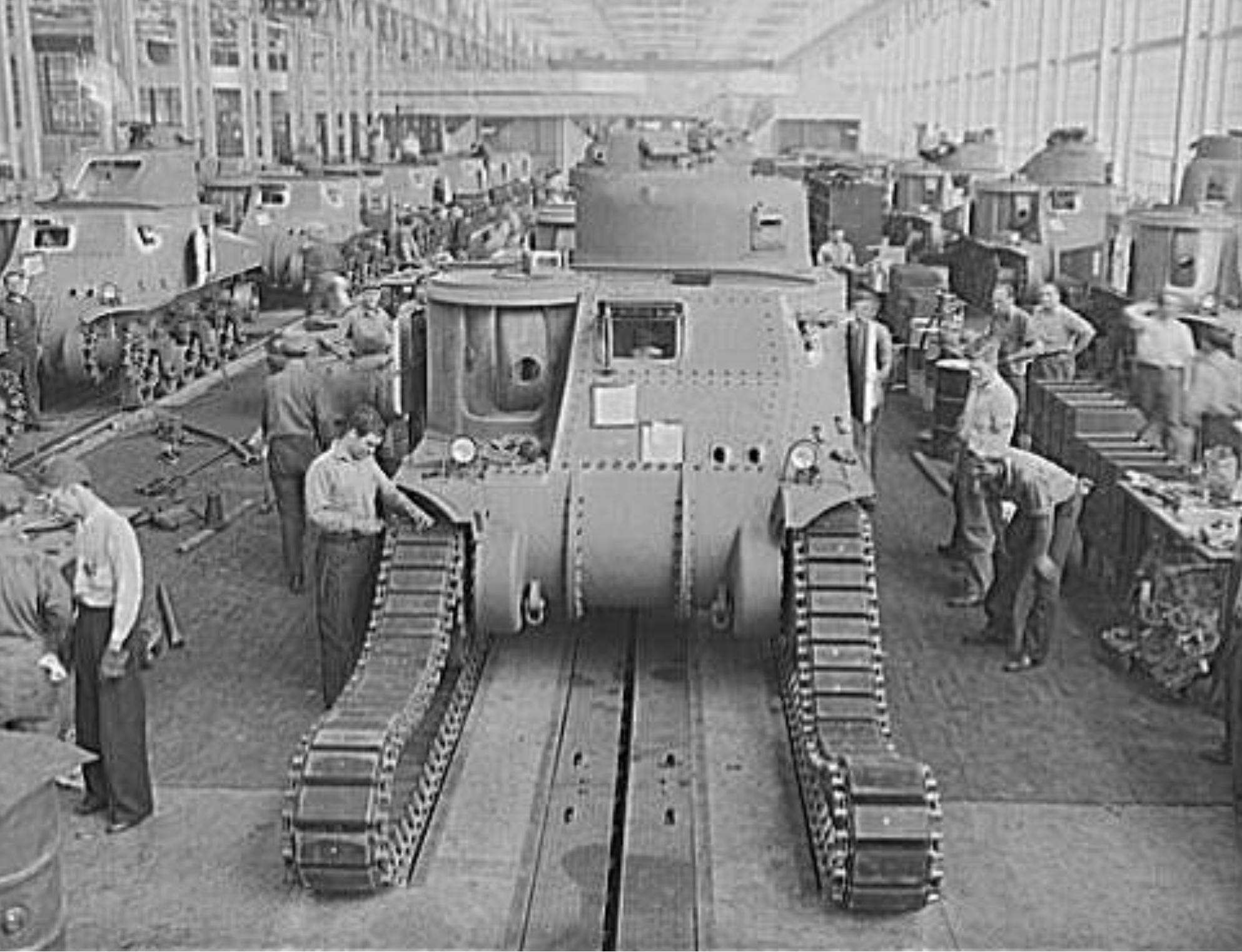 Workers fitting tracks onto a M3 tank at the Detroit Arsenal Tank Plant