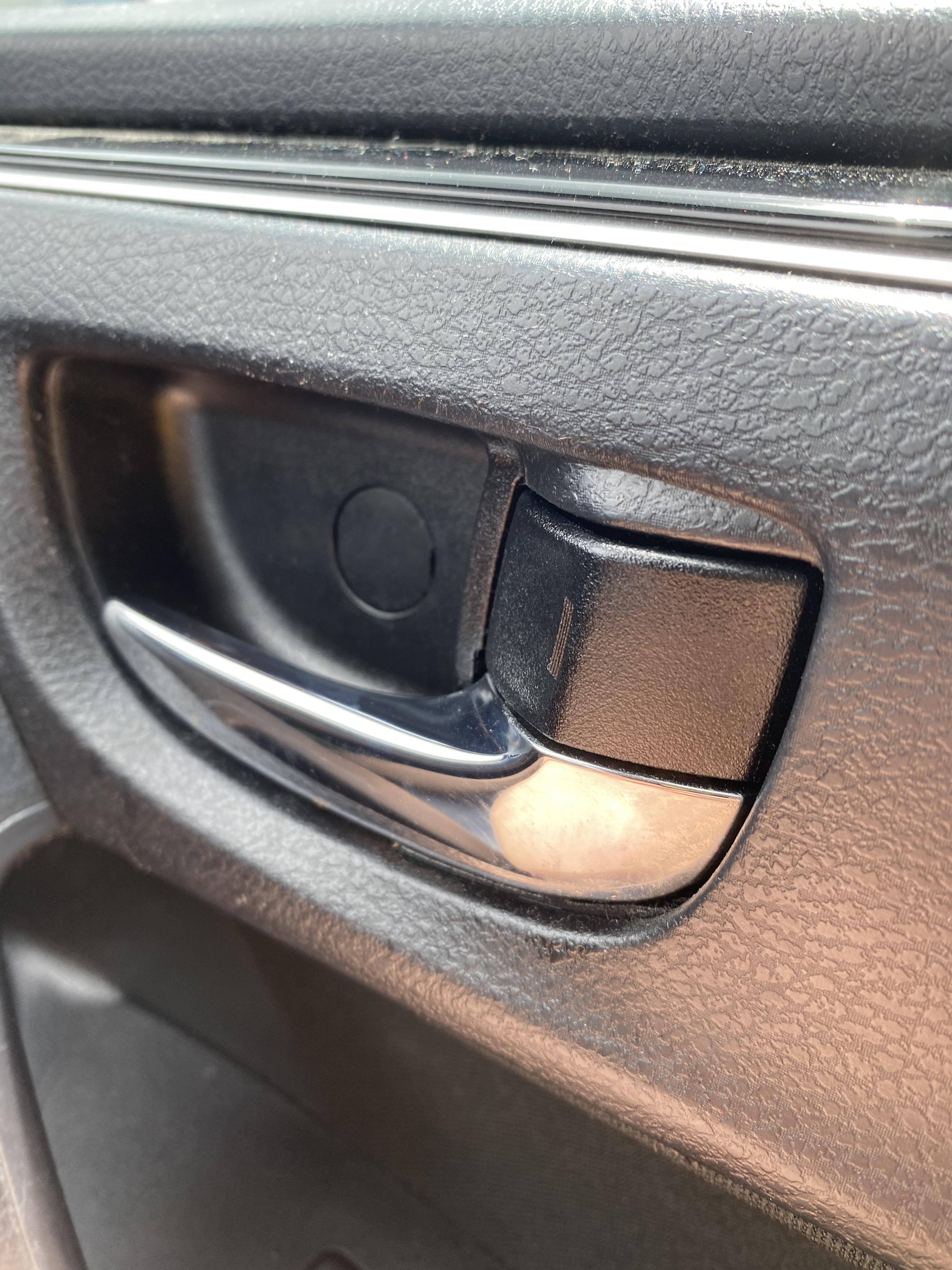 What is this little circle thing right above my car door handle? r