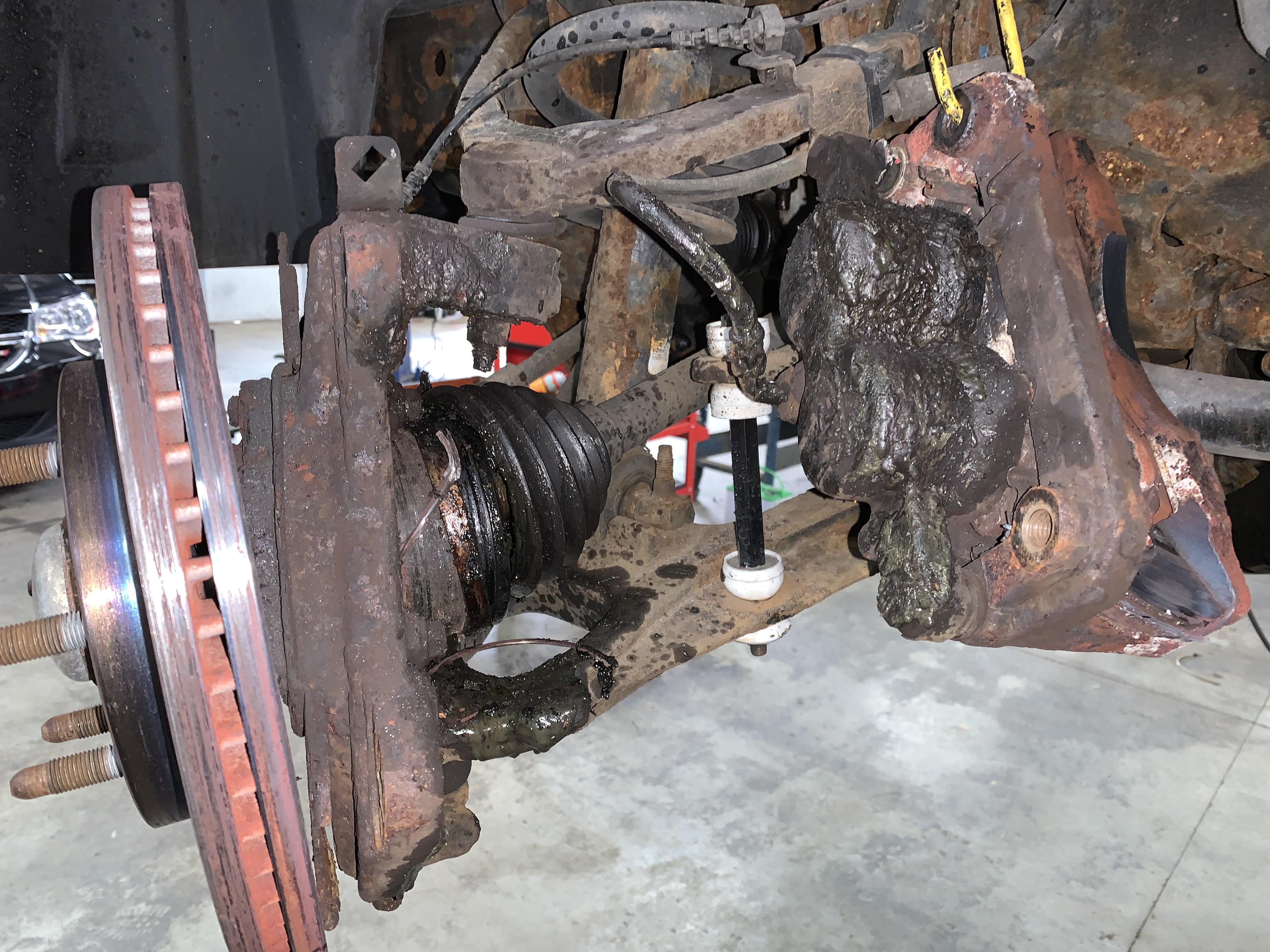 Hub bearing failed. CV axle blew up, rotor ground caliper bracket down