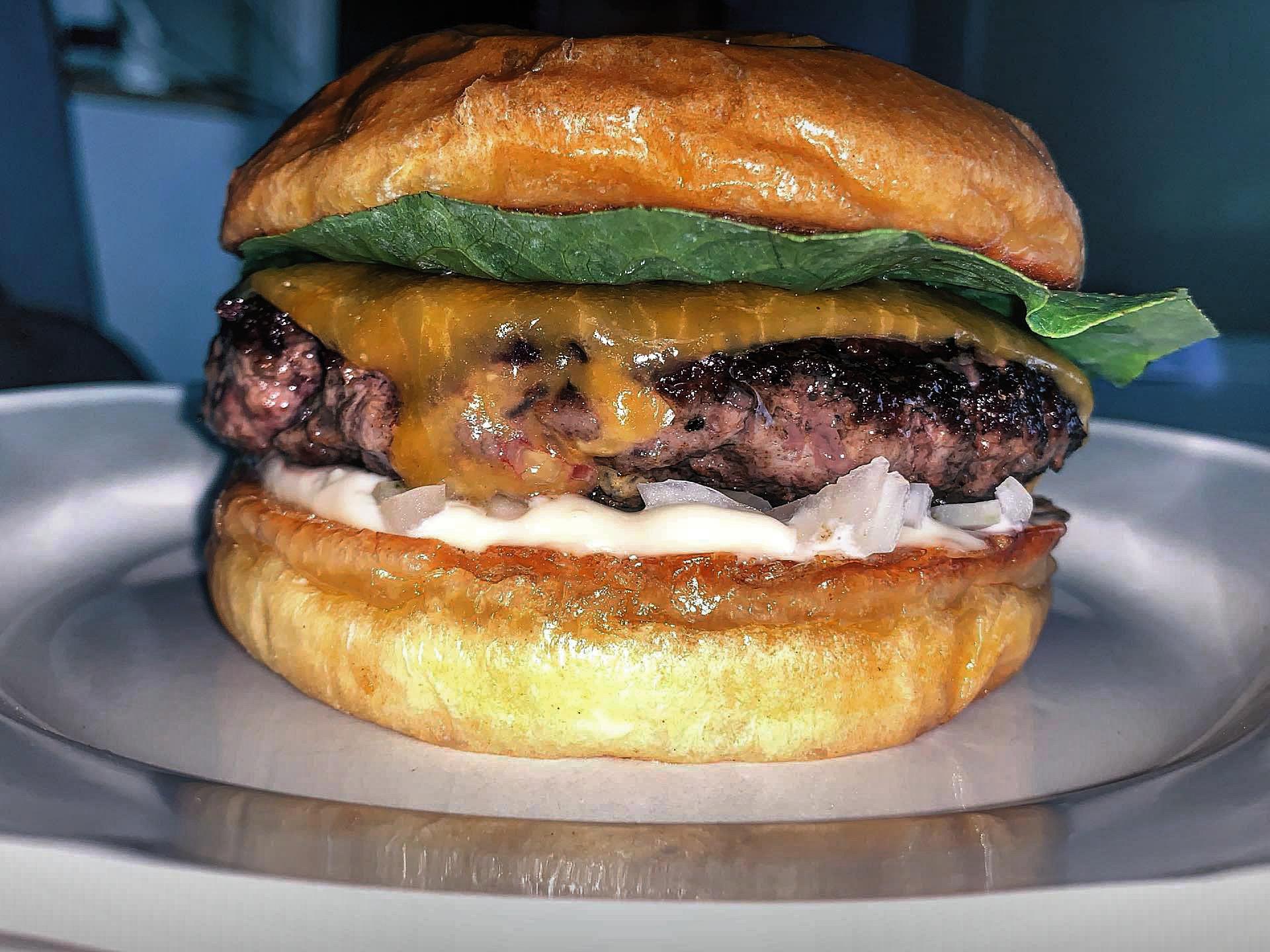 Brioche bun toasted in beef tallow, butterhead lettuce, aged cheddar