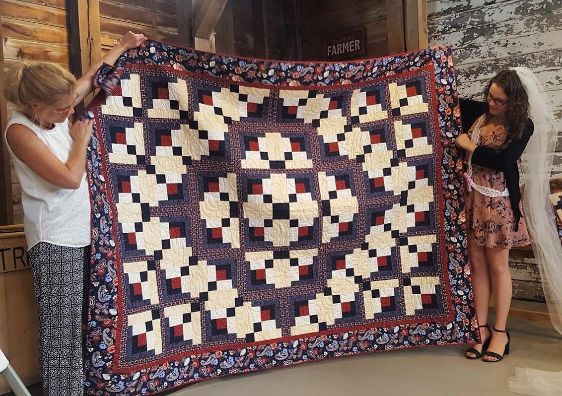 Queen sized quilt my mom made for my bridal shower gift! Stitched with