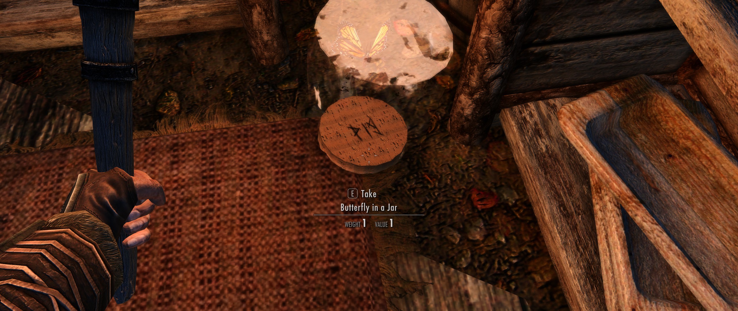 Just noticed there's writing underneath the butterfly in a jar lid