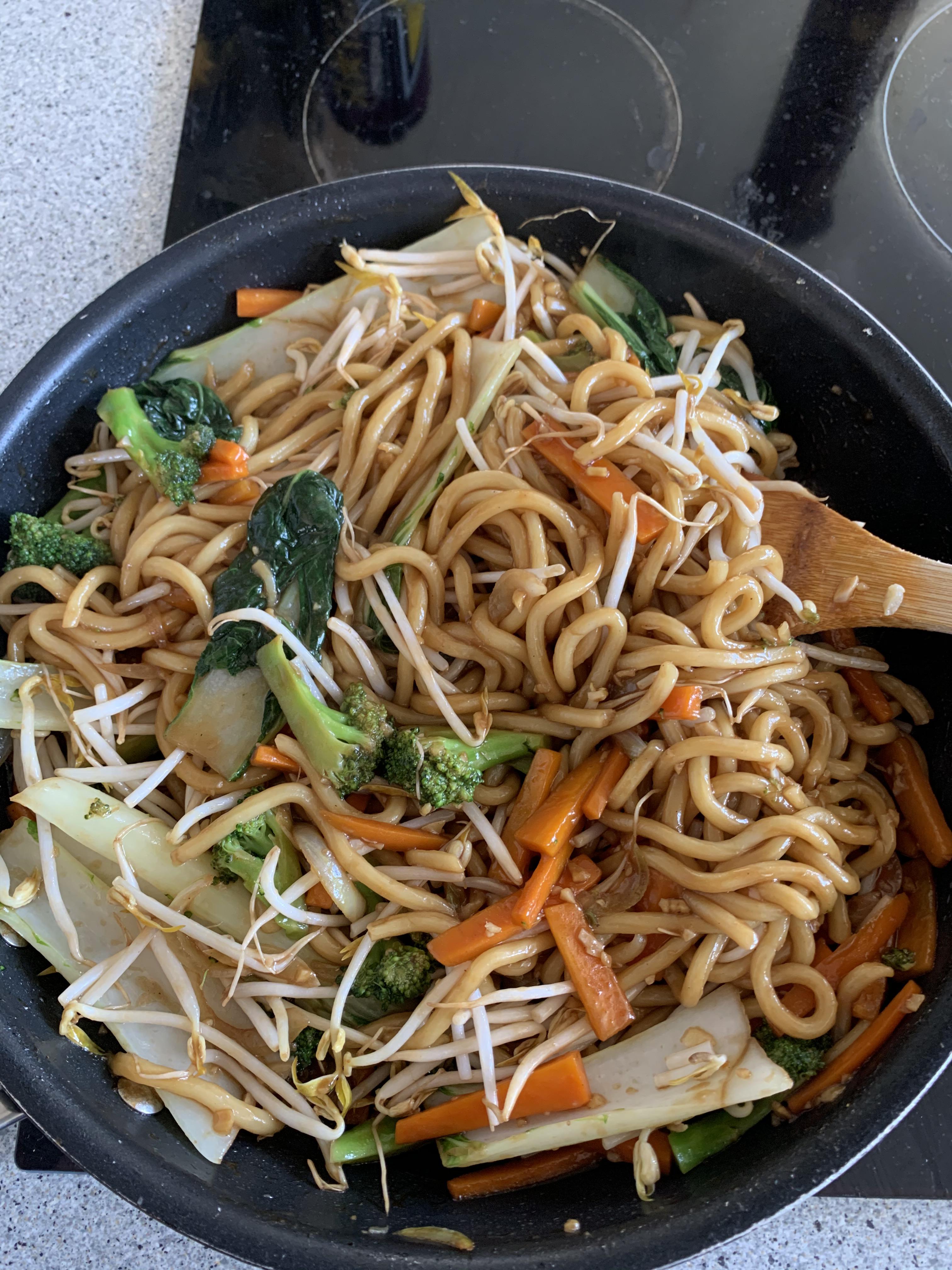 Vegan noodle stir fry ginger, garlic, onion, pak choy, broccoli