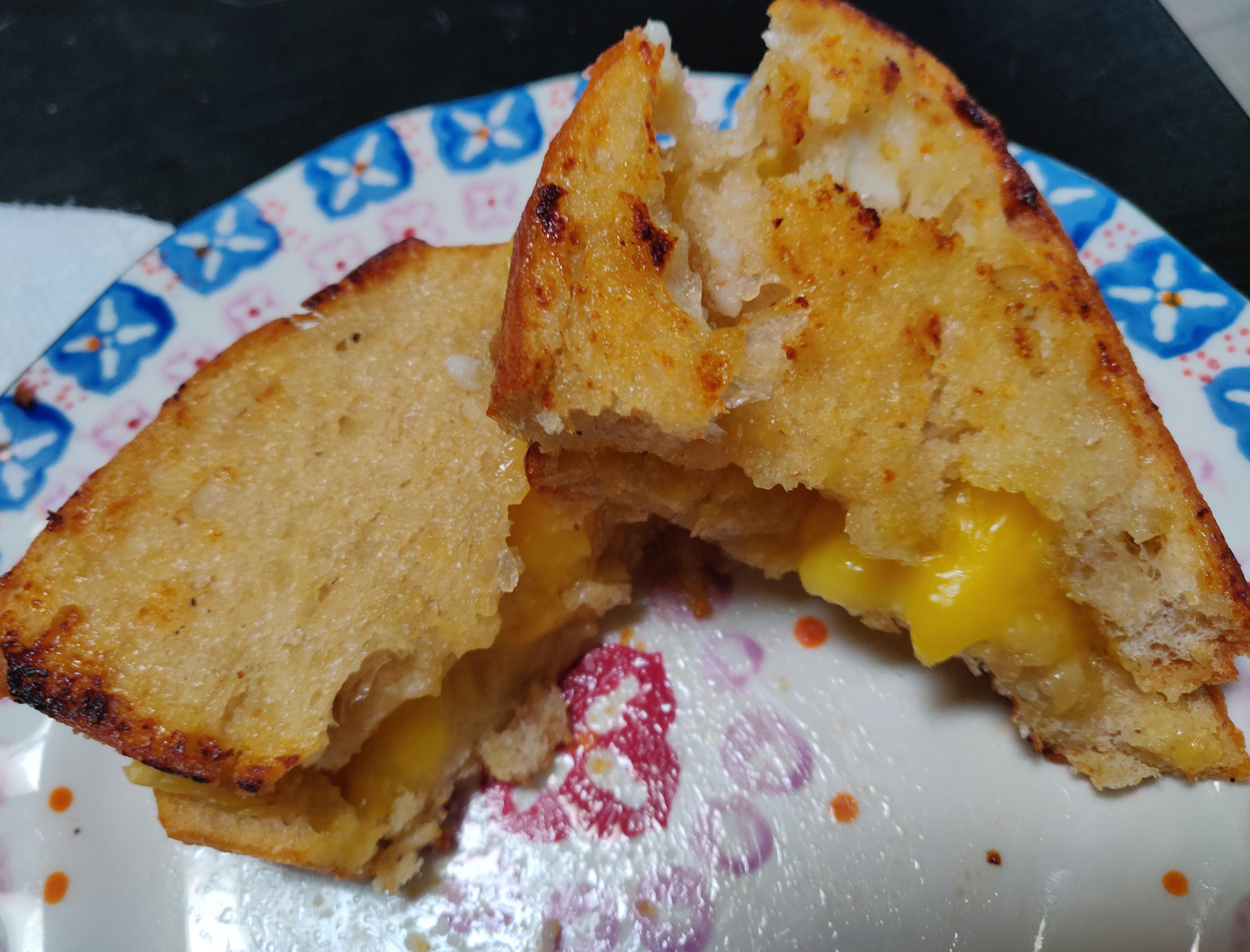 Enjoying this crispy sourdough oven baked "grilled cheese" before