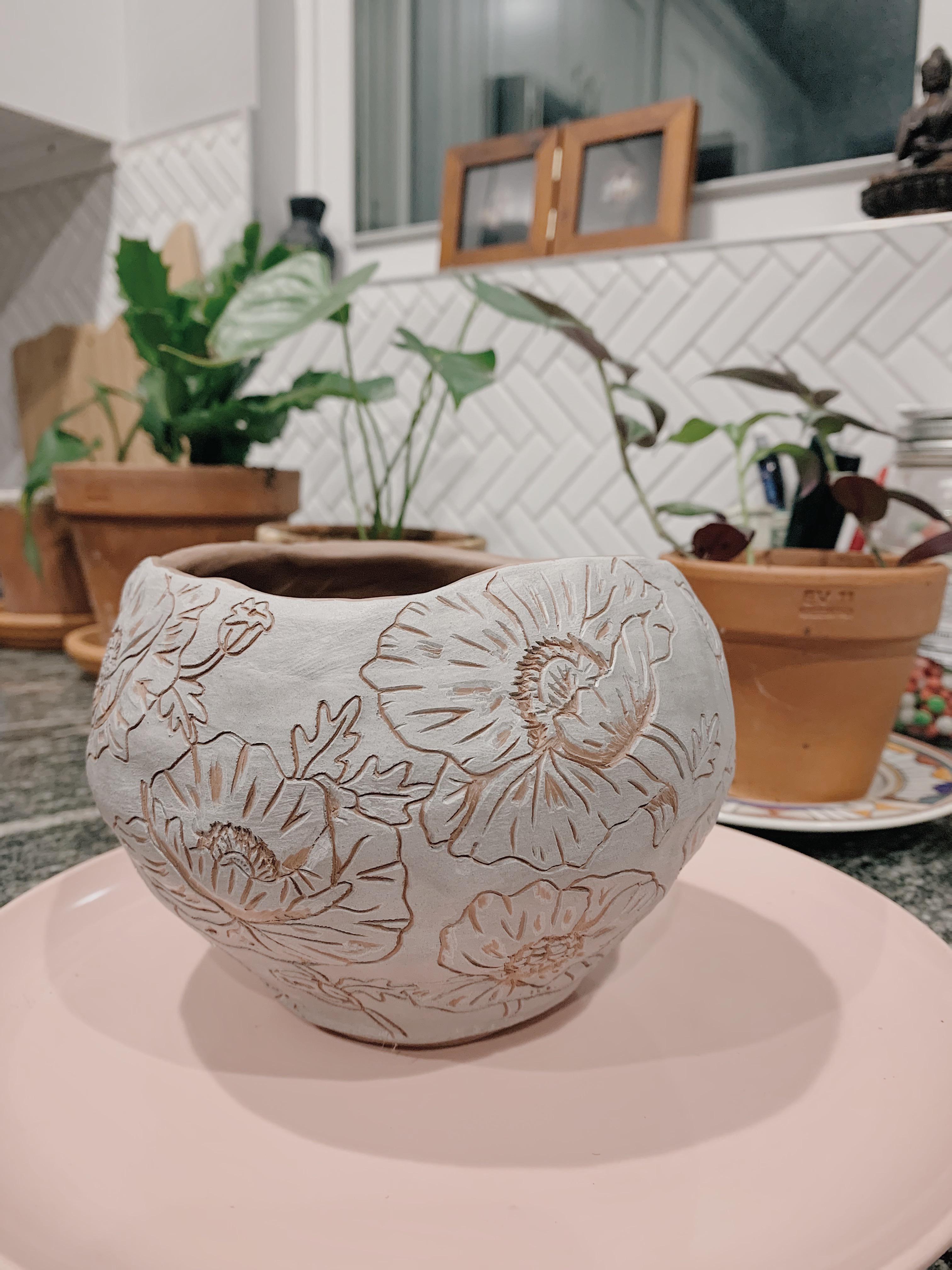 I coiled the pot, added white slip and then made some poppy sgraffito