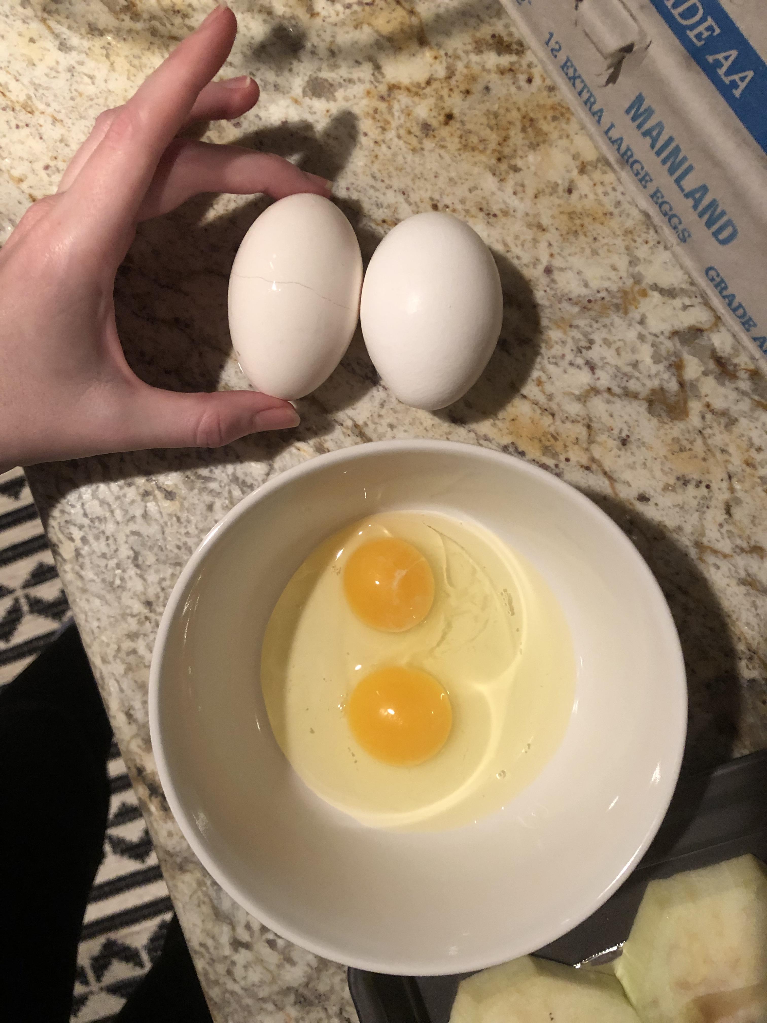 This long skinny egg had two yolks in it (normal egg on the right for