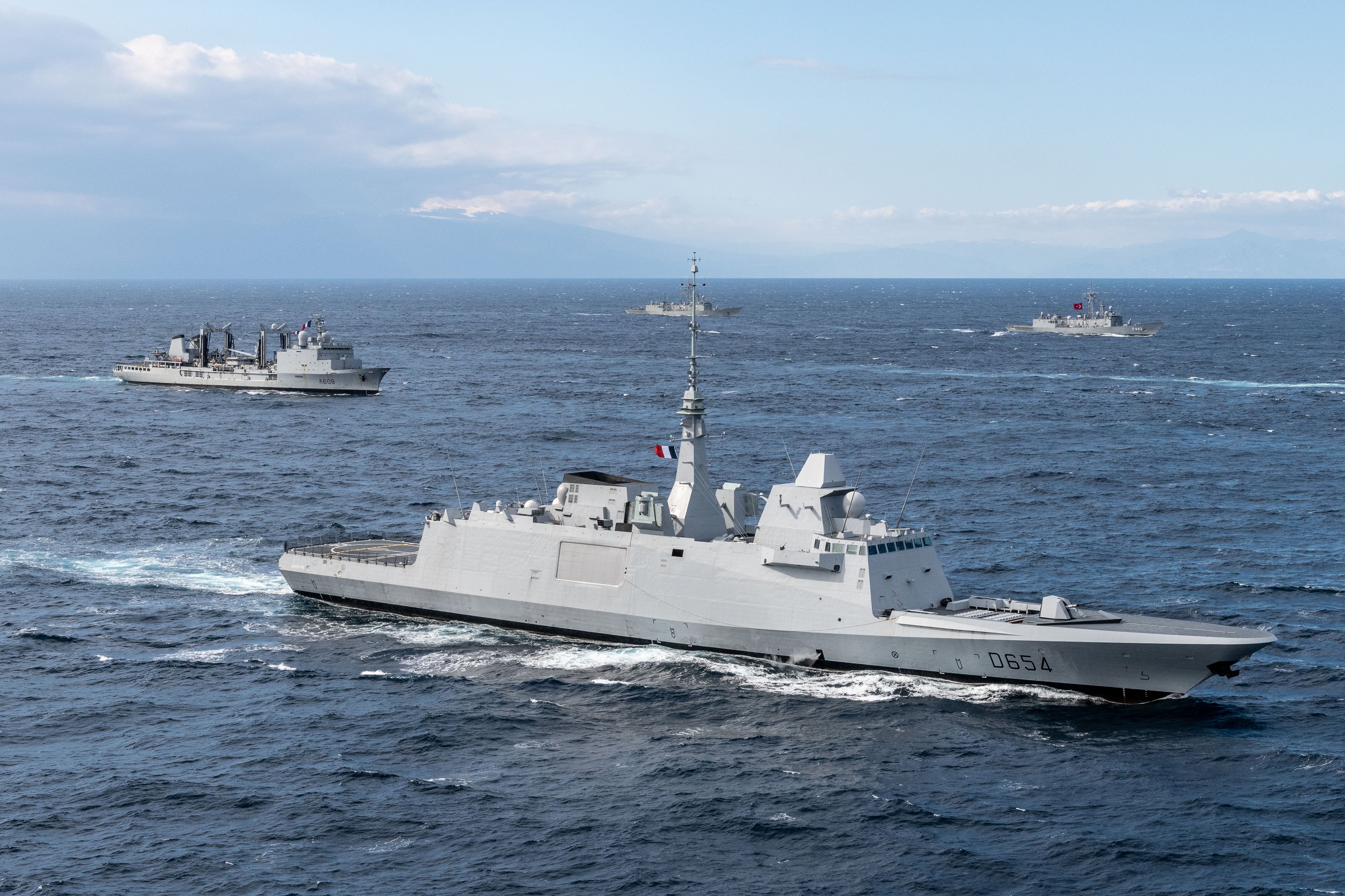 French Navy FREMM frigate Auvergne sailing with an oiler and Turkish