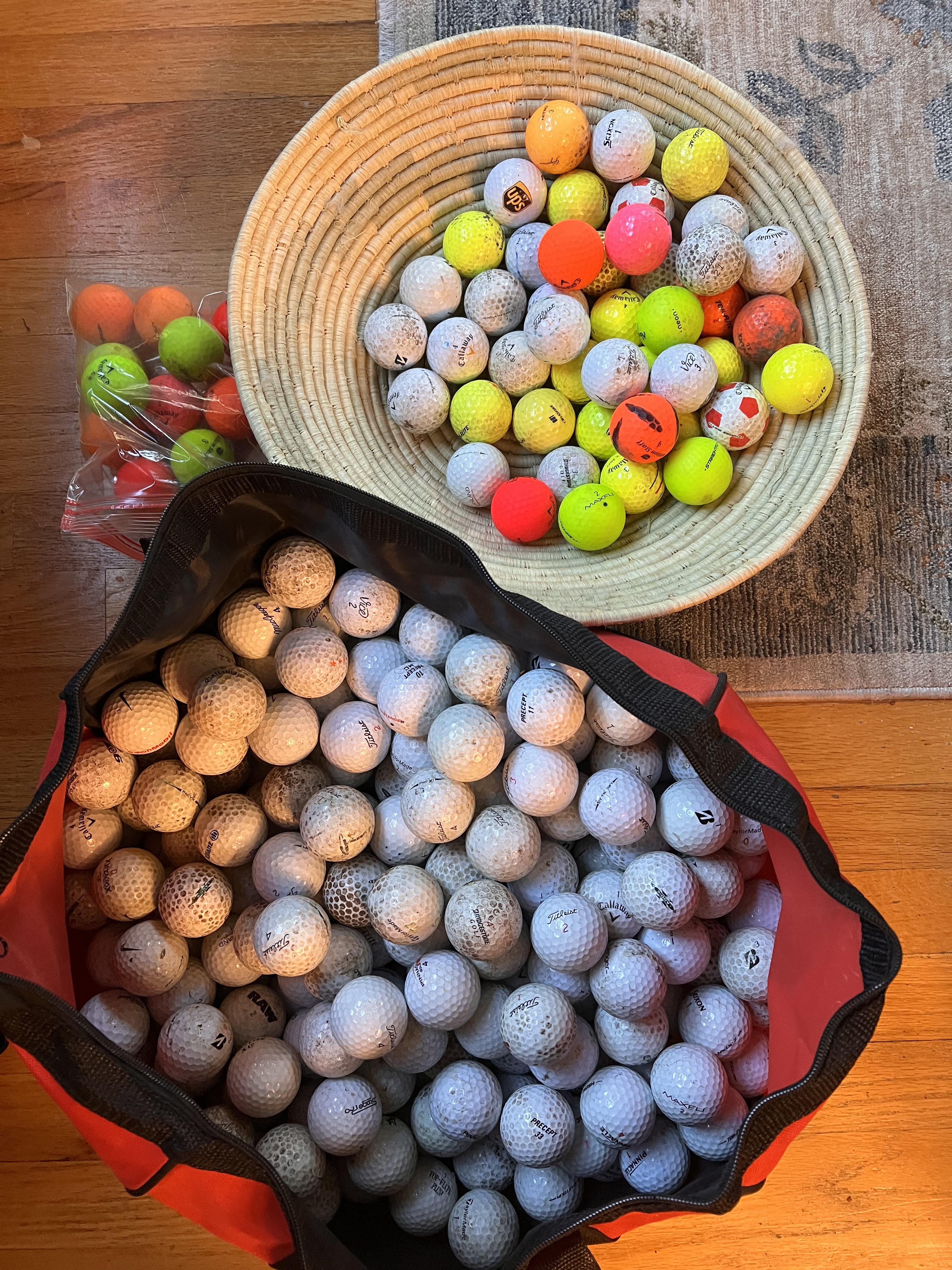 Golf balls collected over a few months walking in the woods by a golf