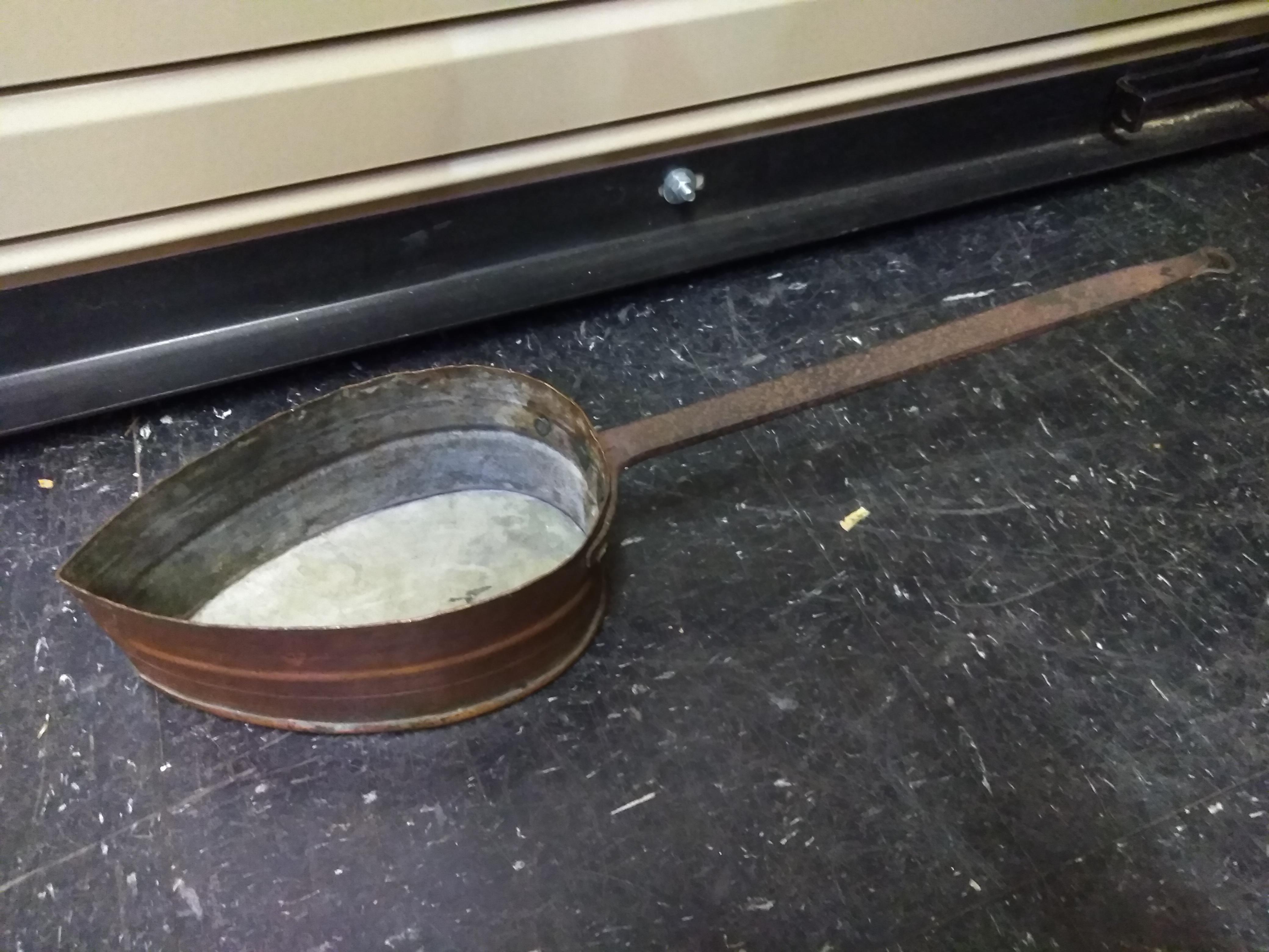 Strangely shaped copper pan with iron handle. Was told it might have