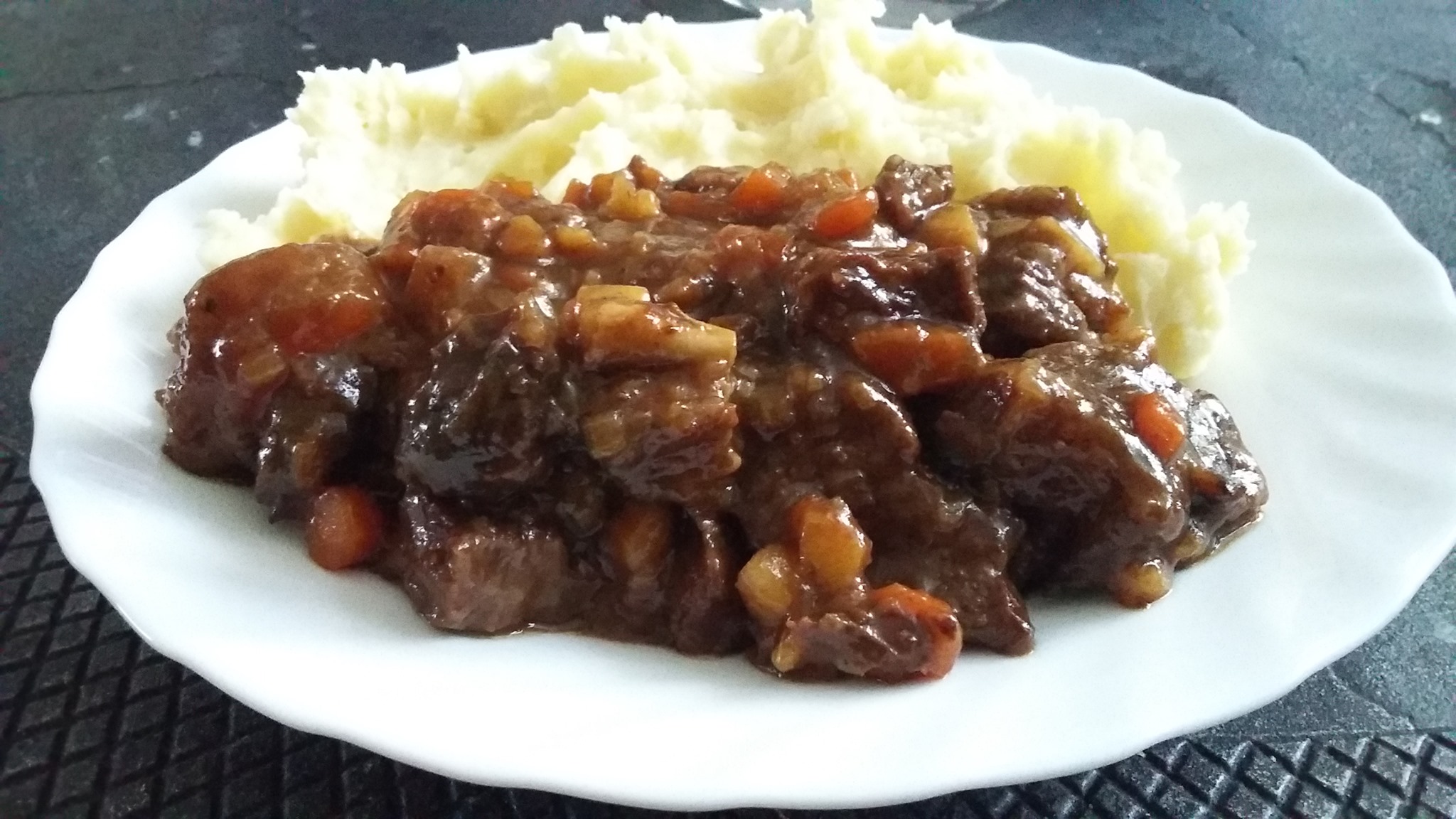 Dutch beef stew with beer and cranberry jam made in the dutch oven