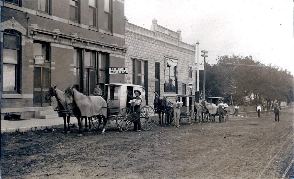 Crete mail carriers ready for delivery, outside of the post office