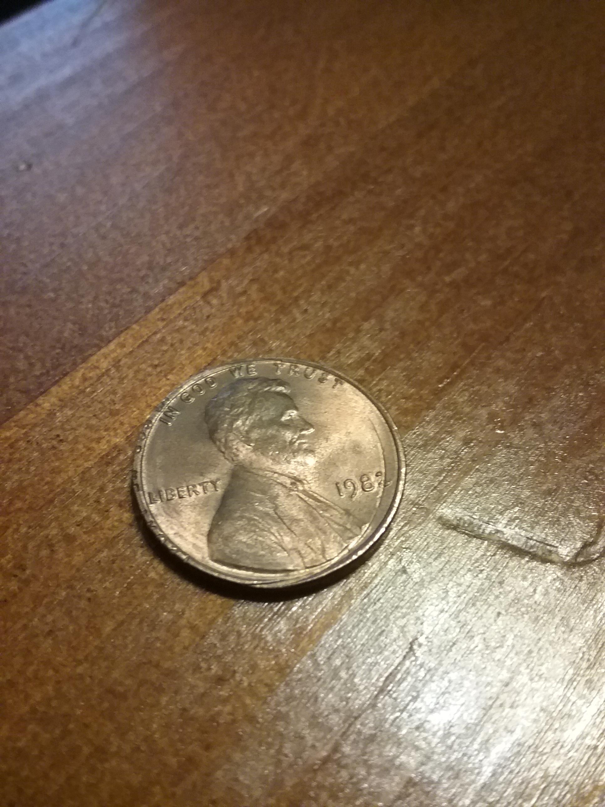 Through the 2, is that a minting error or coin roller machine damage