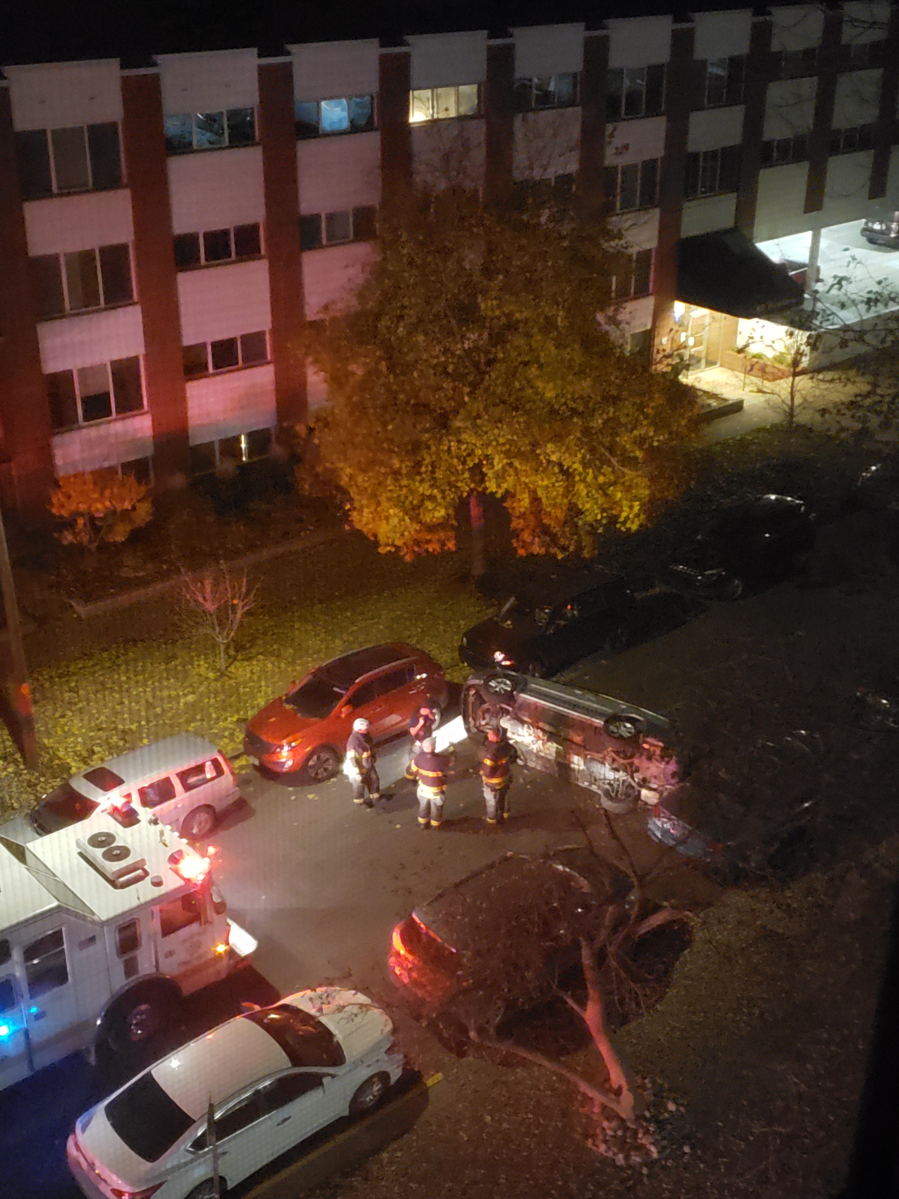 A car flipped onto it's side in front of my apartment in cap hill at 2