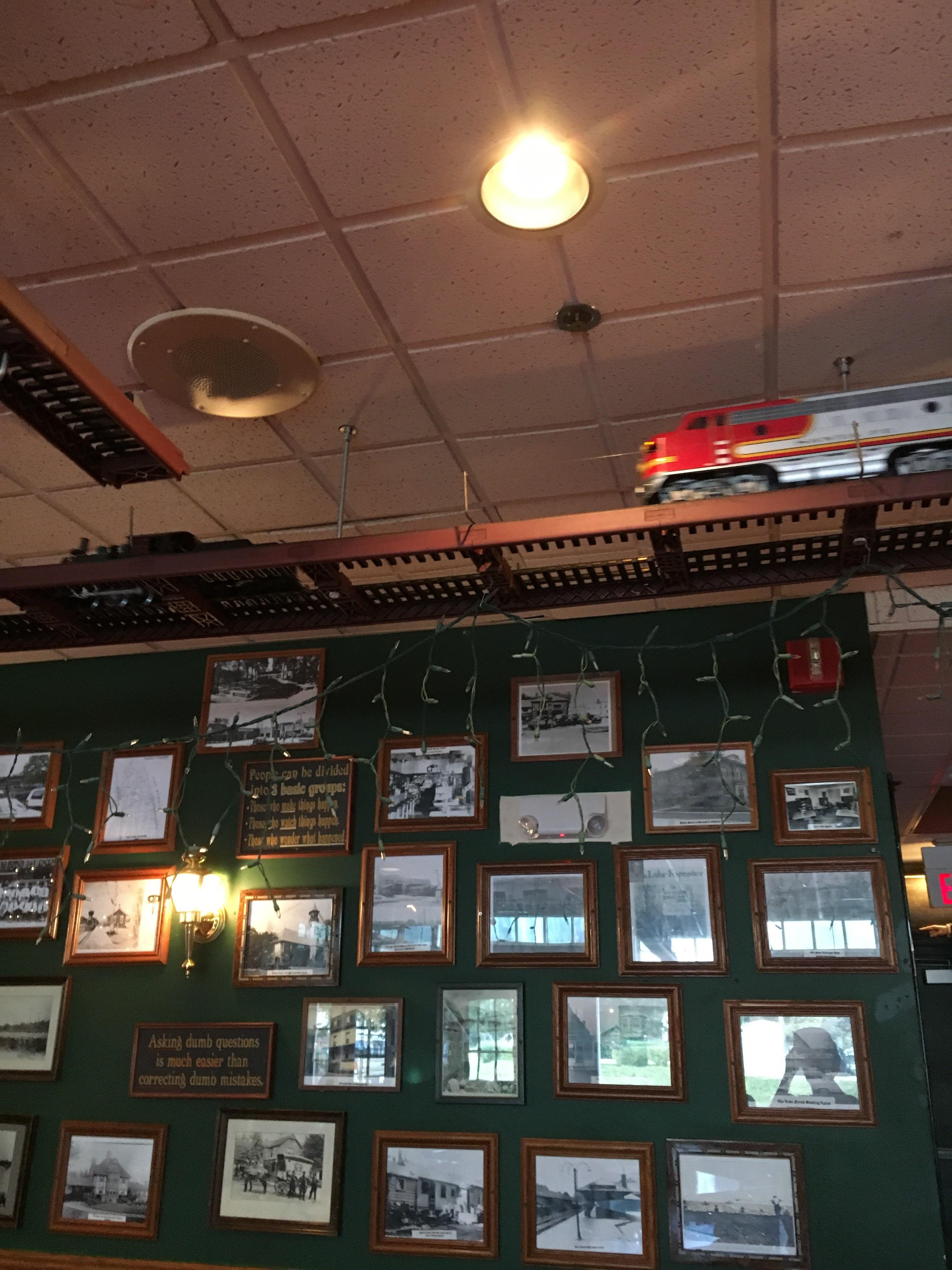 This restaurant has a toy train that rides around the ceiling on