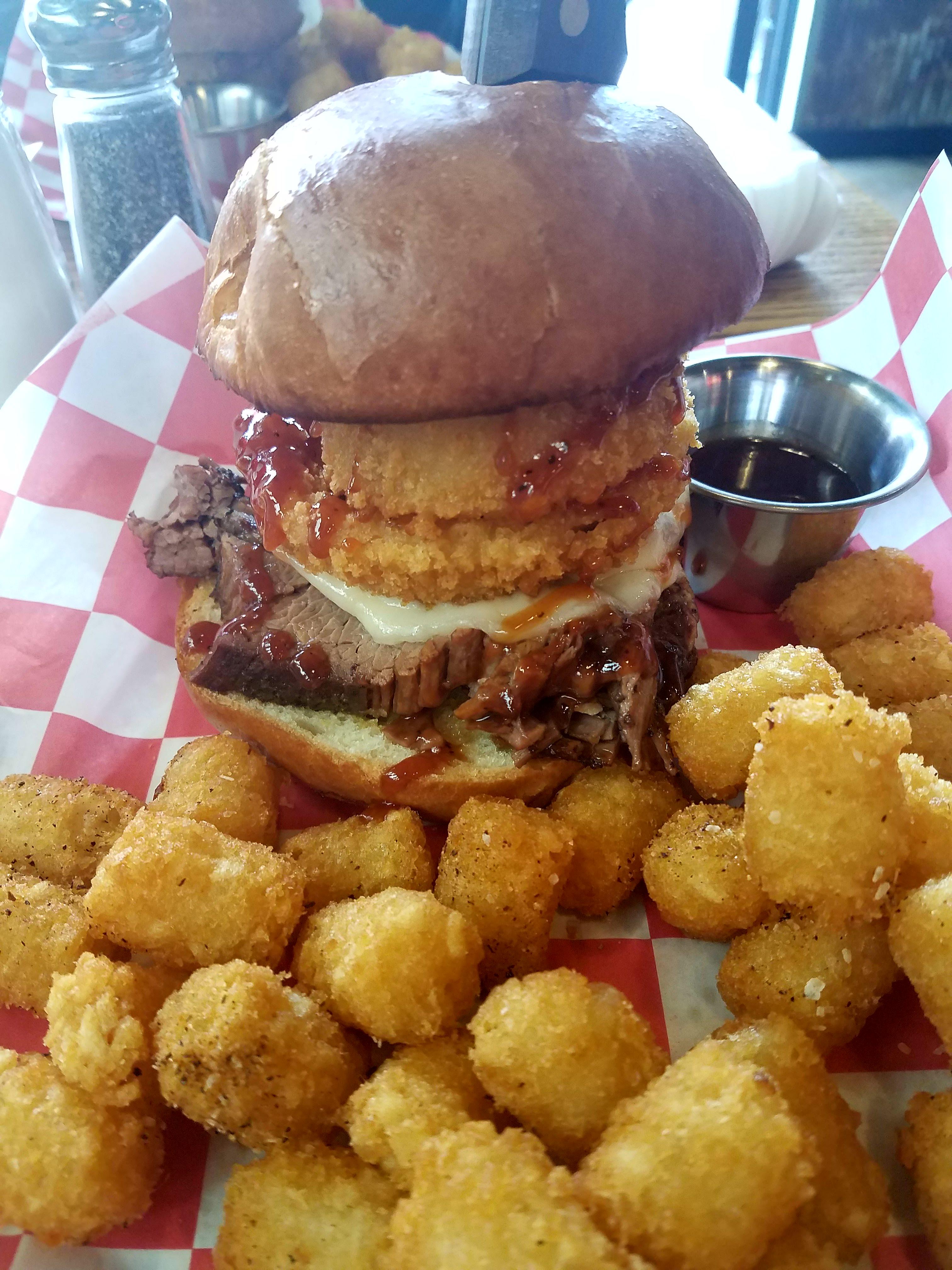 Smoked Brisket, Onion Ring, Provolone Cheese, BBQ Sandwich with Tots