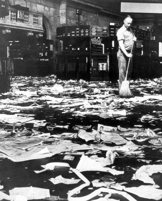 A janitor sweeps the floor of New York Stock Exchange following the