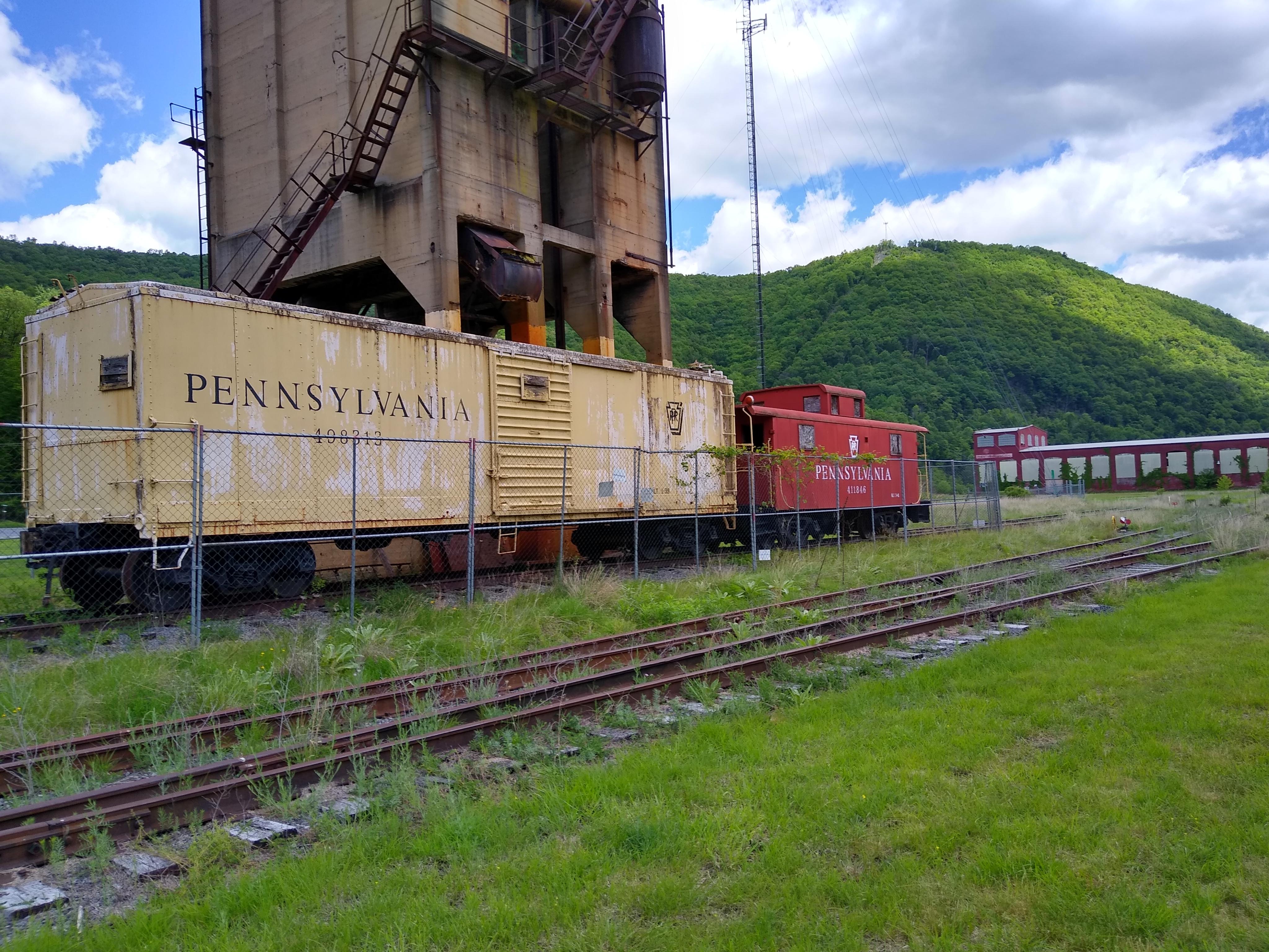 Reefer and cabin car imprisoned at Renovo, PA outside the former shops