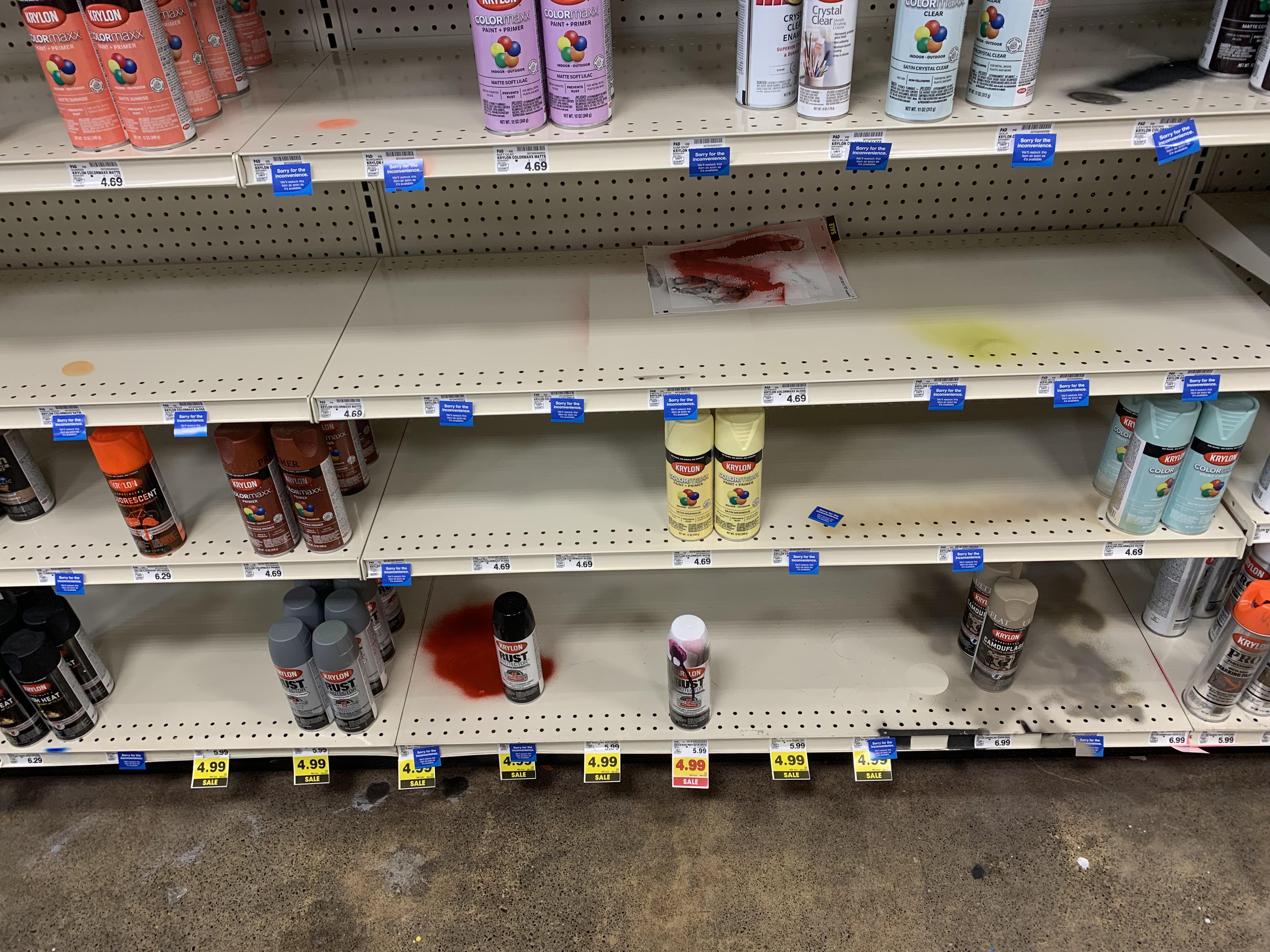 People testing their spray paint color on Fred Meyer’s shelves r
