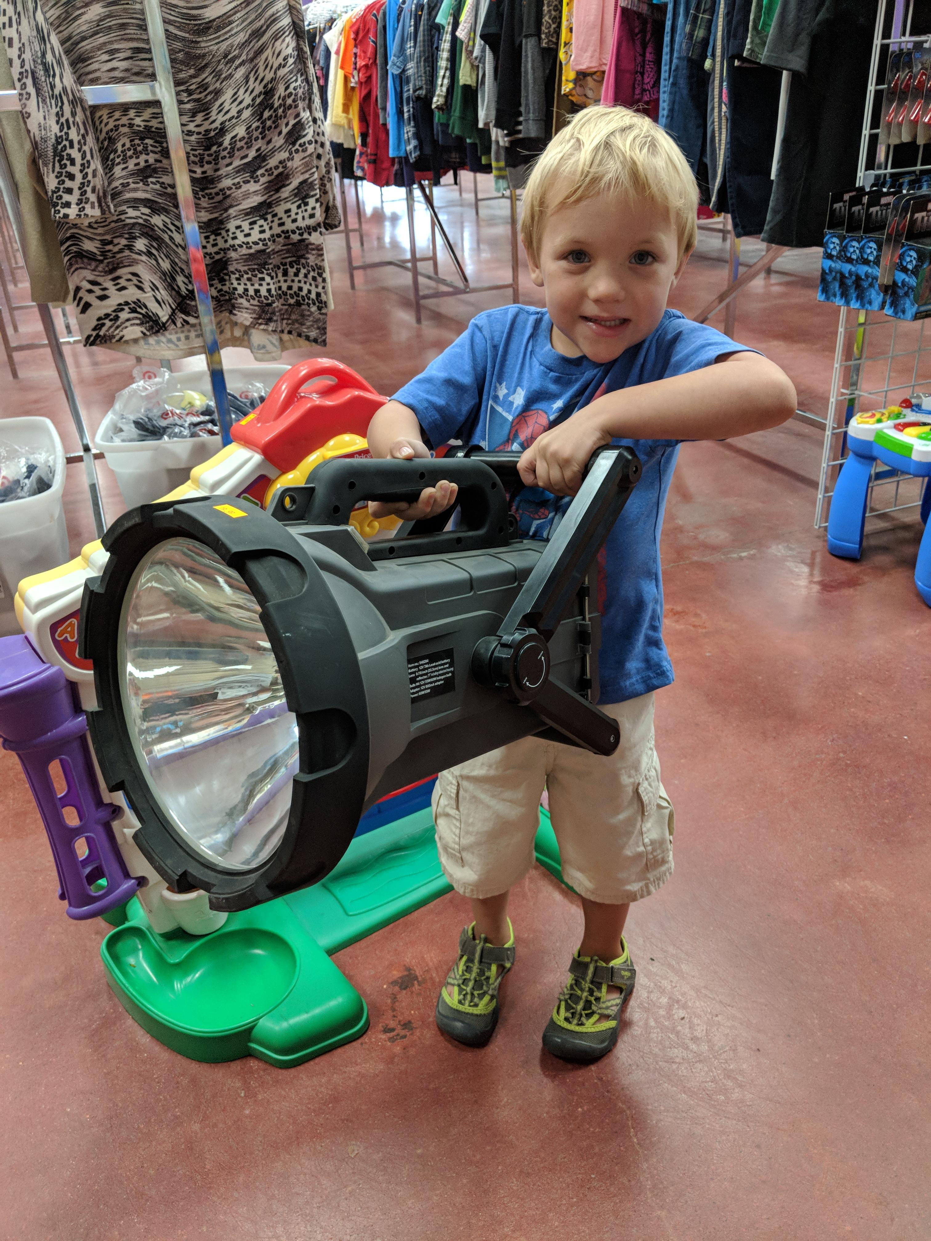 Giant flashlight we found at a thrift store. My four year old holding