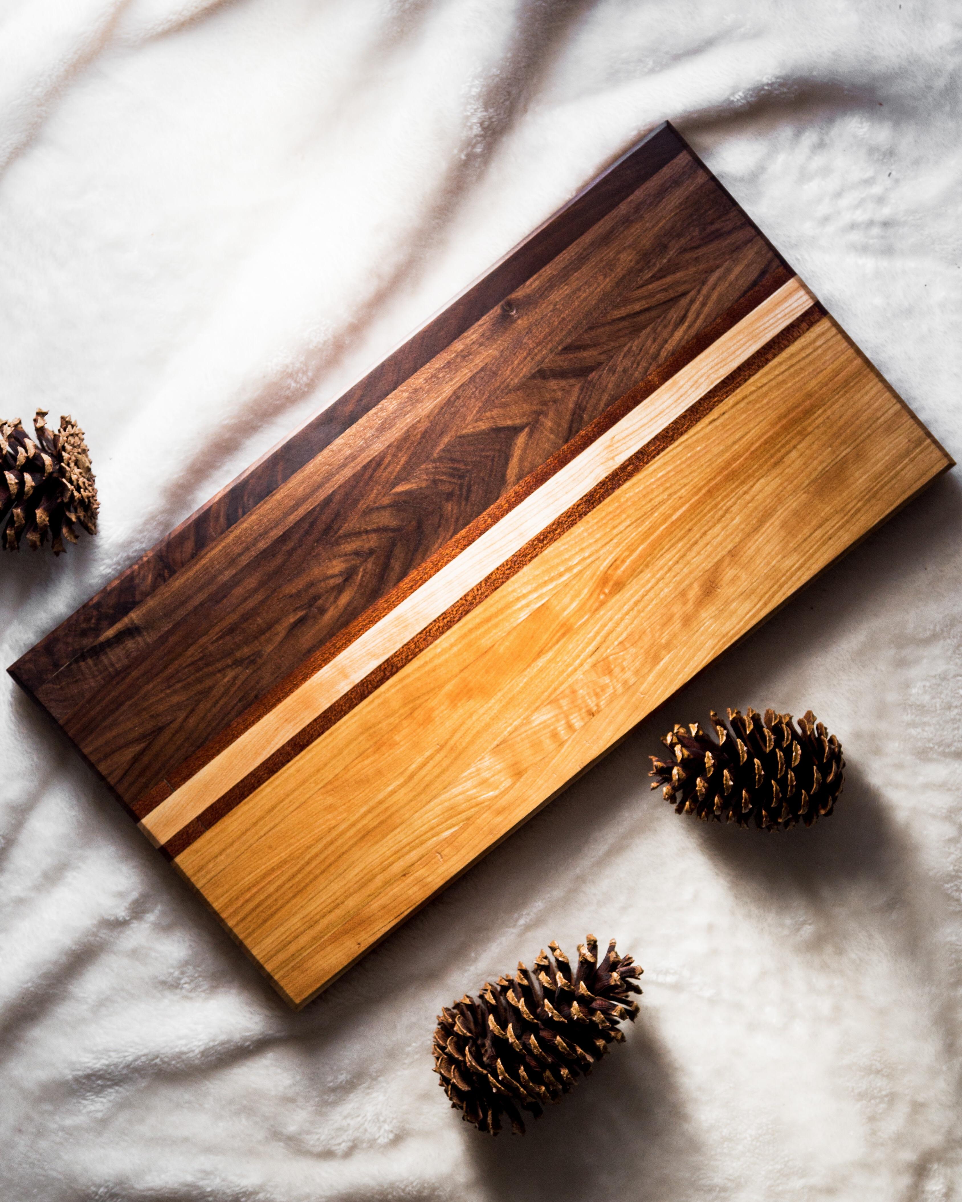 Cutting board designed with walnut and maple, centered with strips of